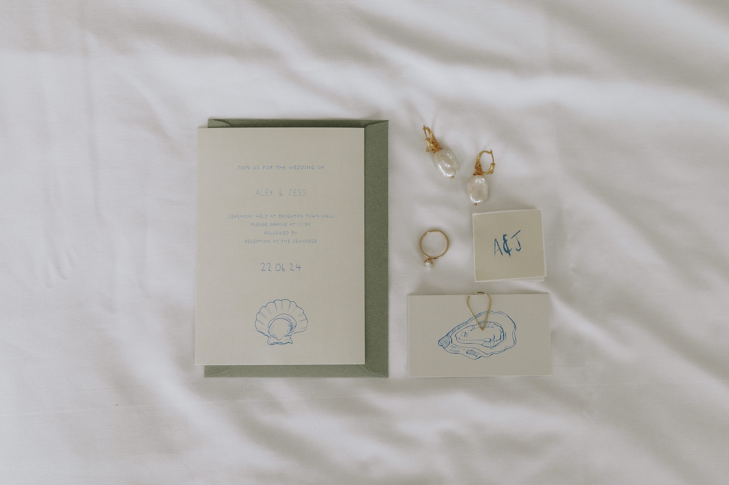 Stationary and jewellery at Brighton wedding. Fine art documentary wedding photography. 