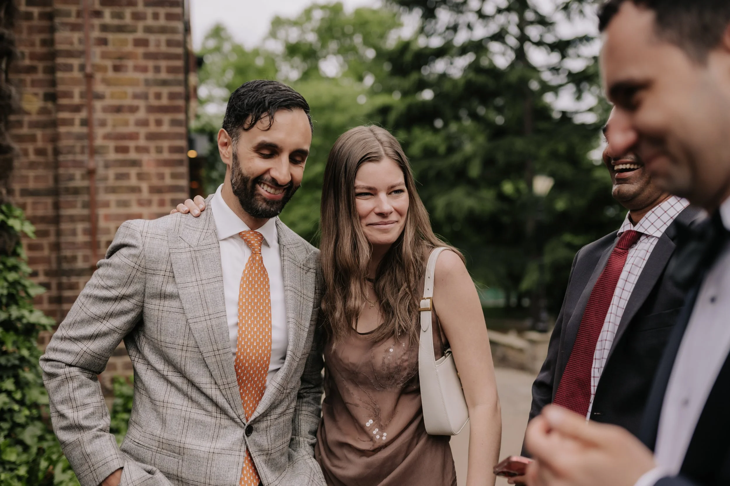 London wedding photography at Belvedere in Holland Park guests hugging and smiling