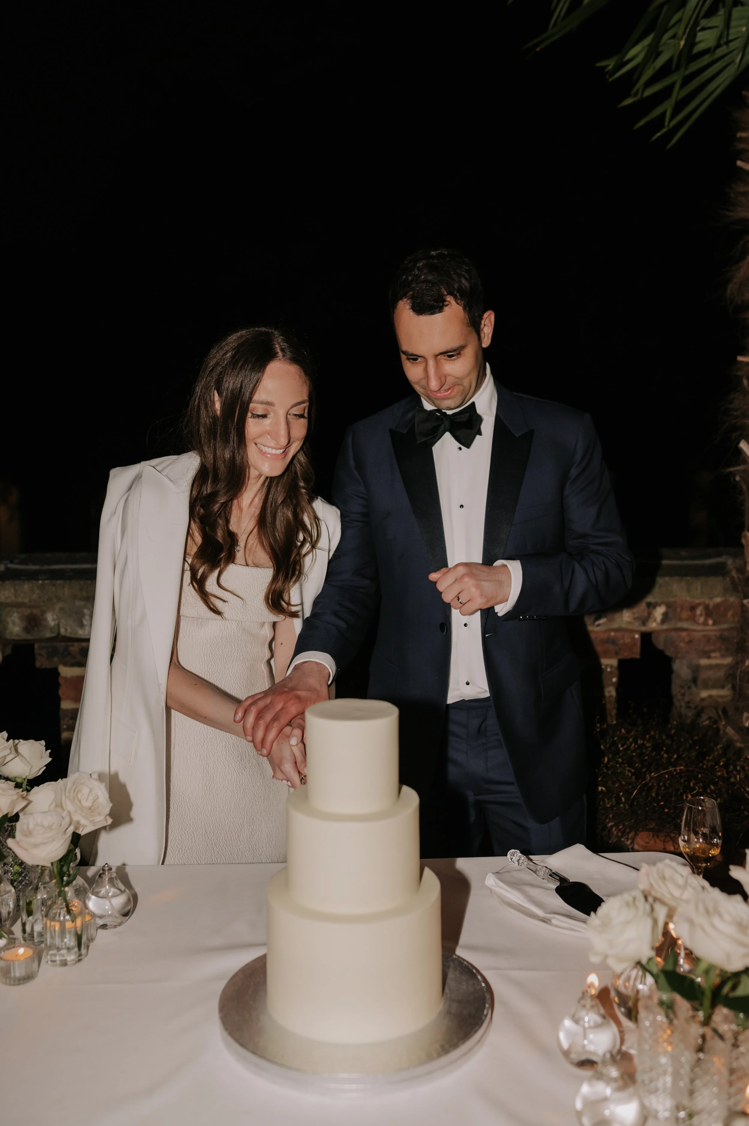 London wedding photography at Belvedere in Holland Park bride and groom cutting cake 