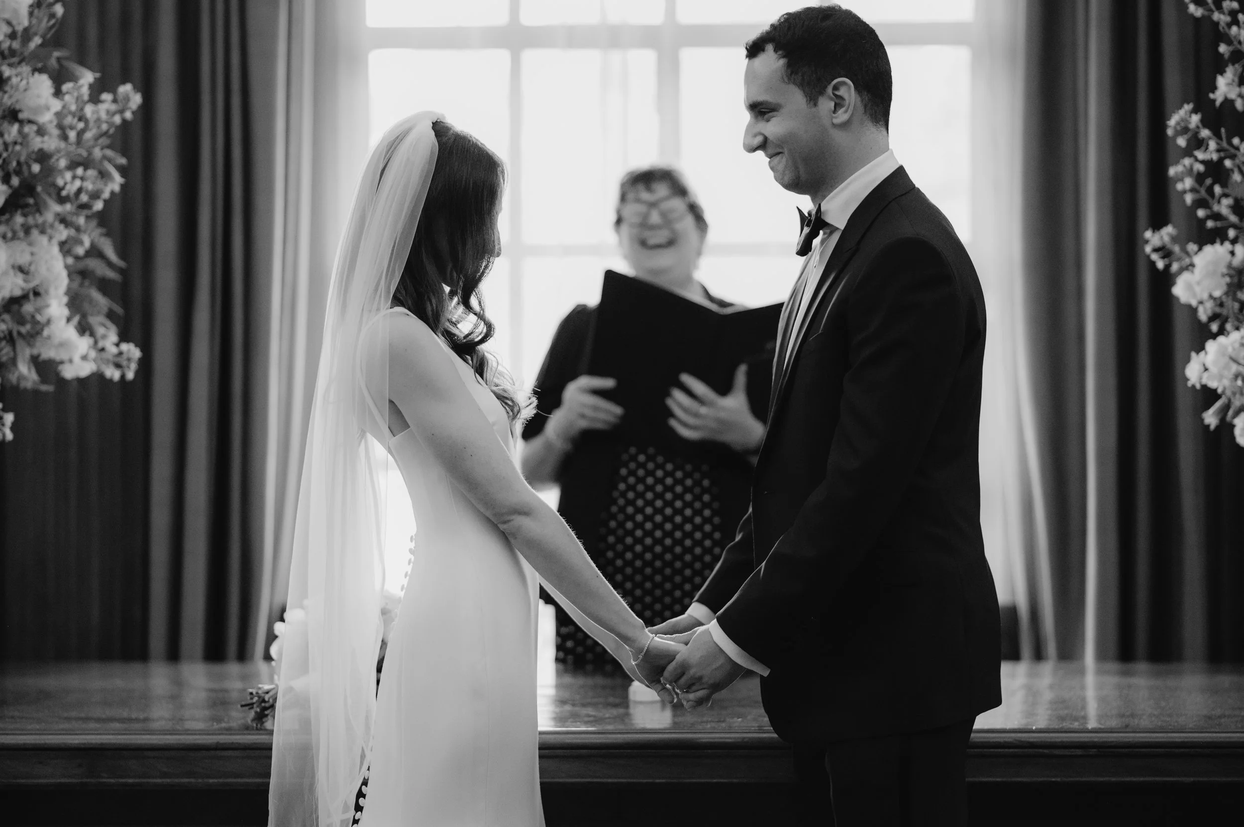 London wedding photography at Marylebone Town Hall bride and groom holding hands at top of aisle 