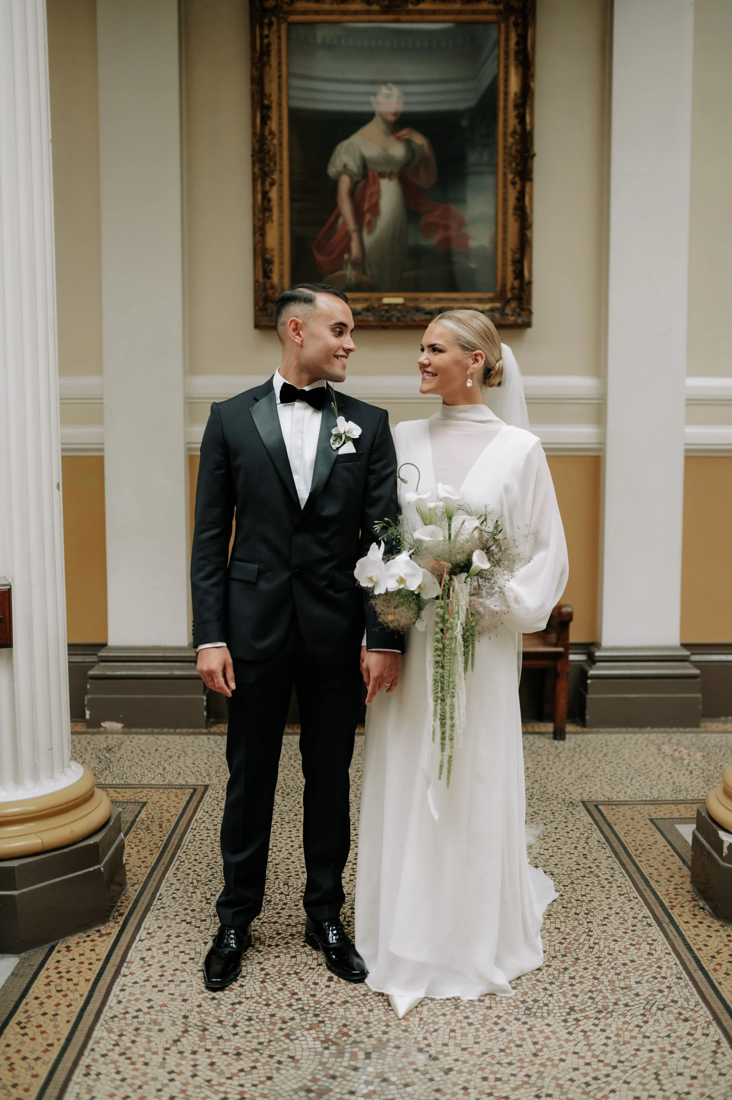 Bride and groom pose for photos at Brighton wedding. Fine art documentary wedding photography. 