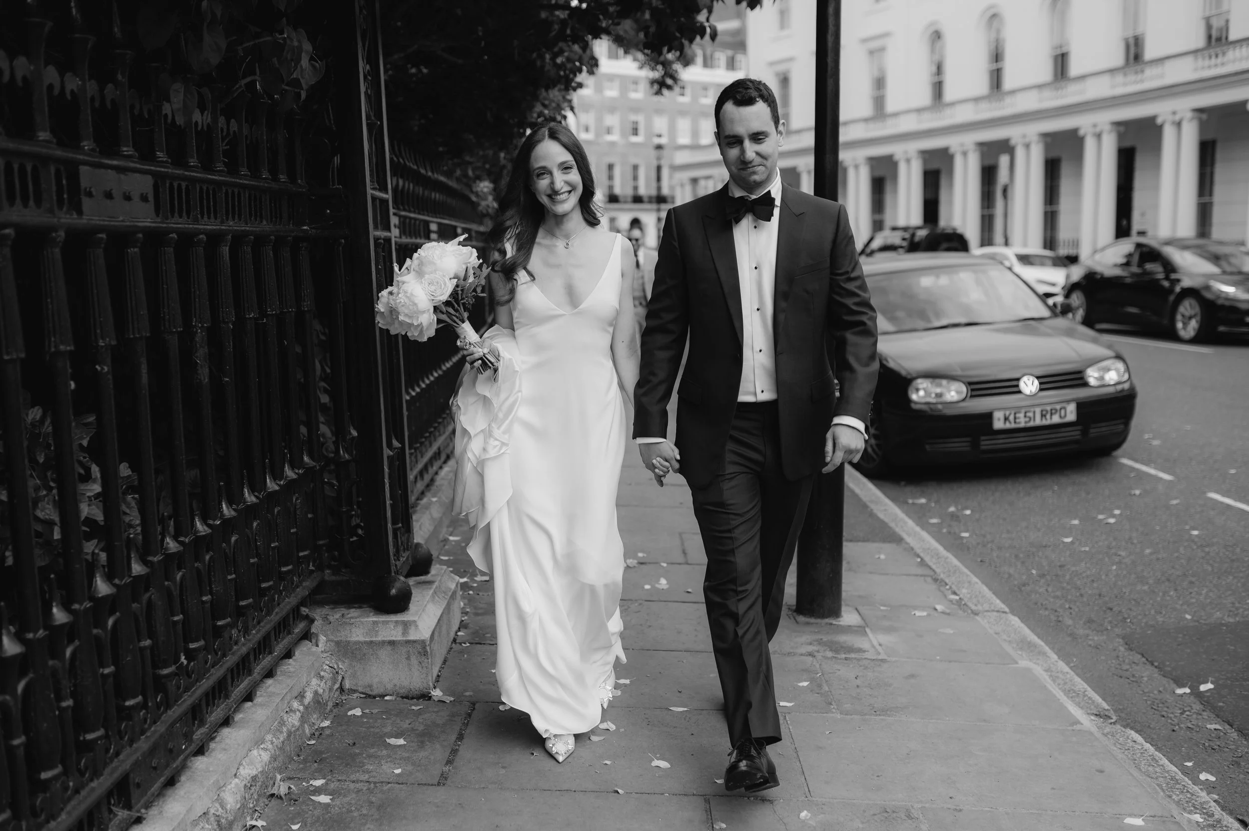 London wedding photography at Marylebone Town Hall bride and groom walking holding hands