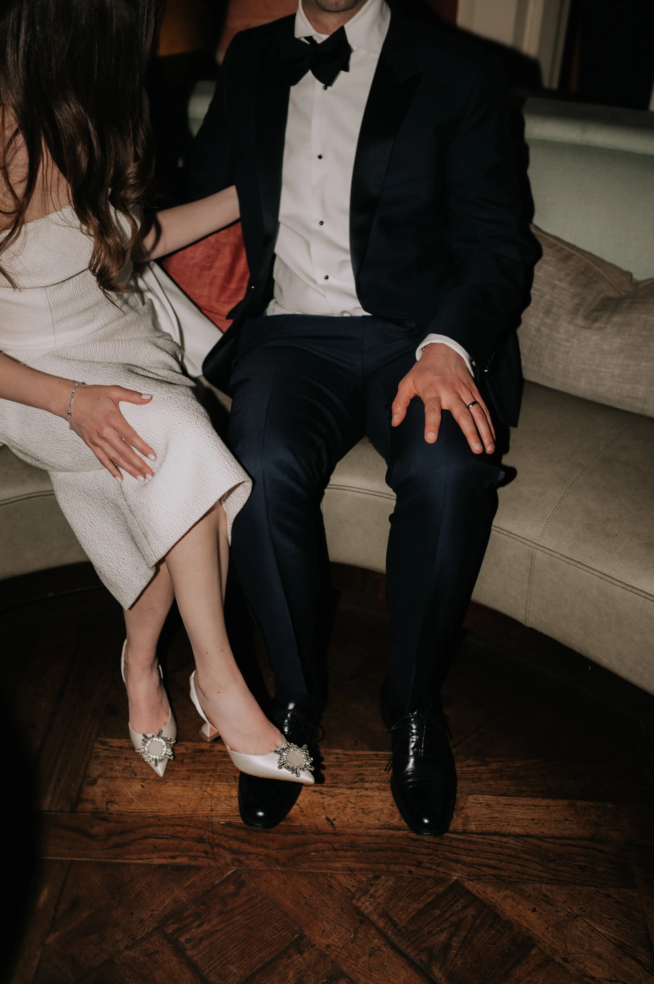 London wedding photography at Belvedere in Holland Park bride and groom sat on sofa