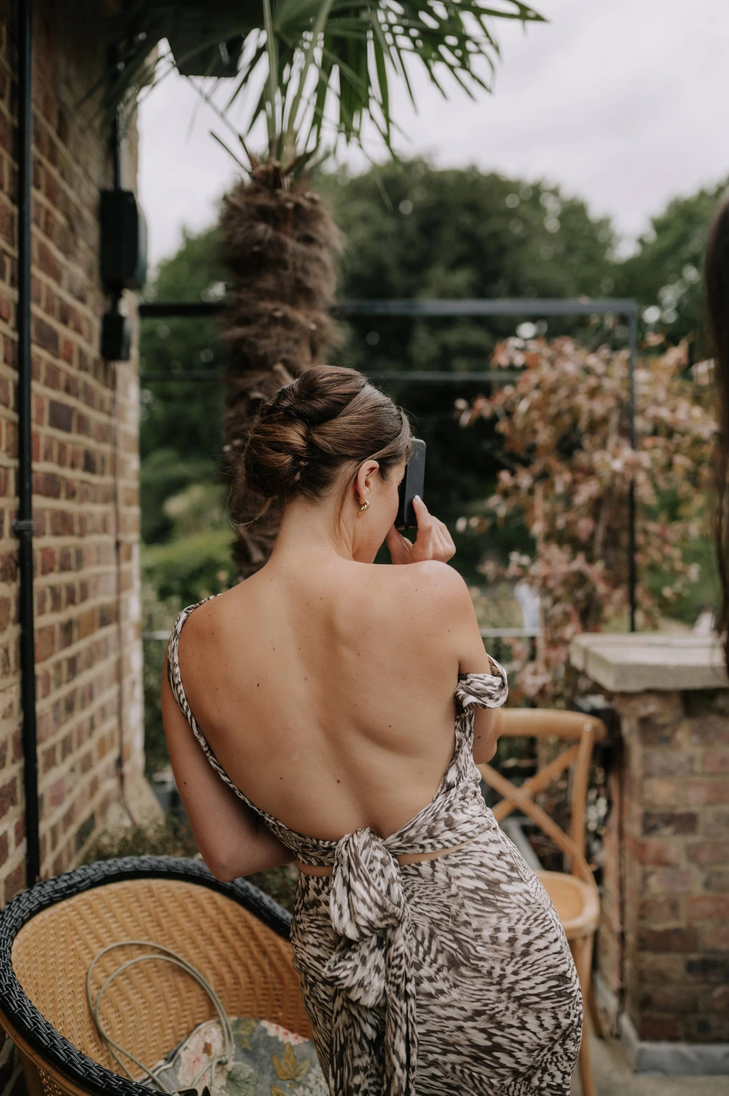 London wedding photography at Belvedere in Holland Park guest taking pcture on camera 