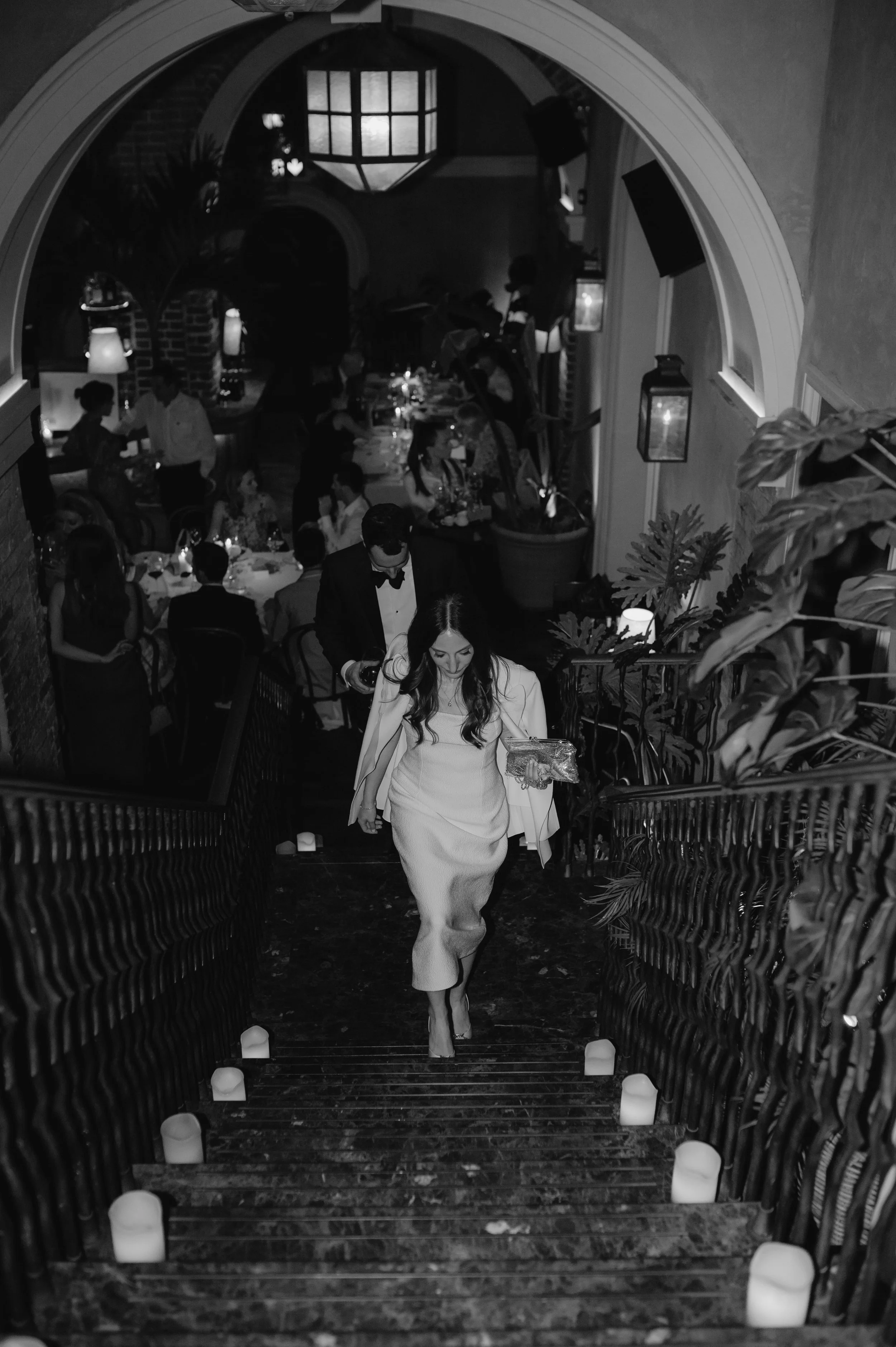 candlelit dinner London wedding photography at Belvedere in Holland Park bride and groom walking up stairs 
