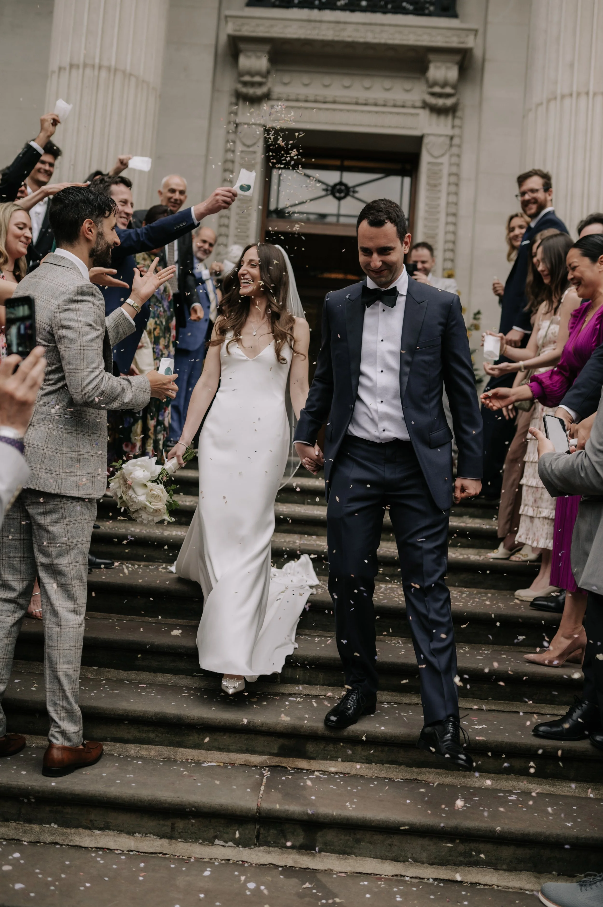 London wedding photography at Marylebone Town Hall bride and groom in confetti tunnel