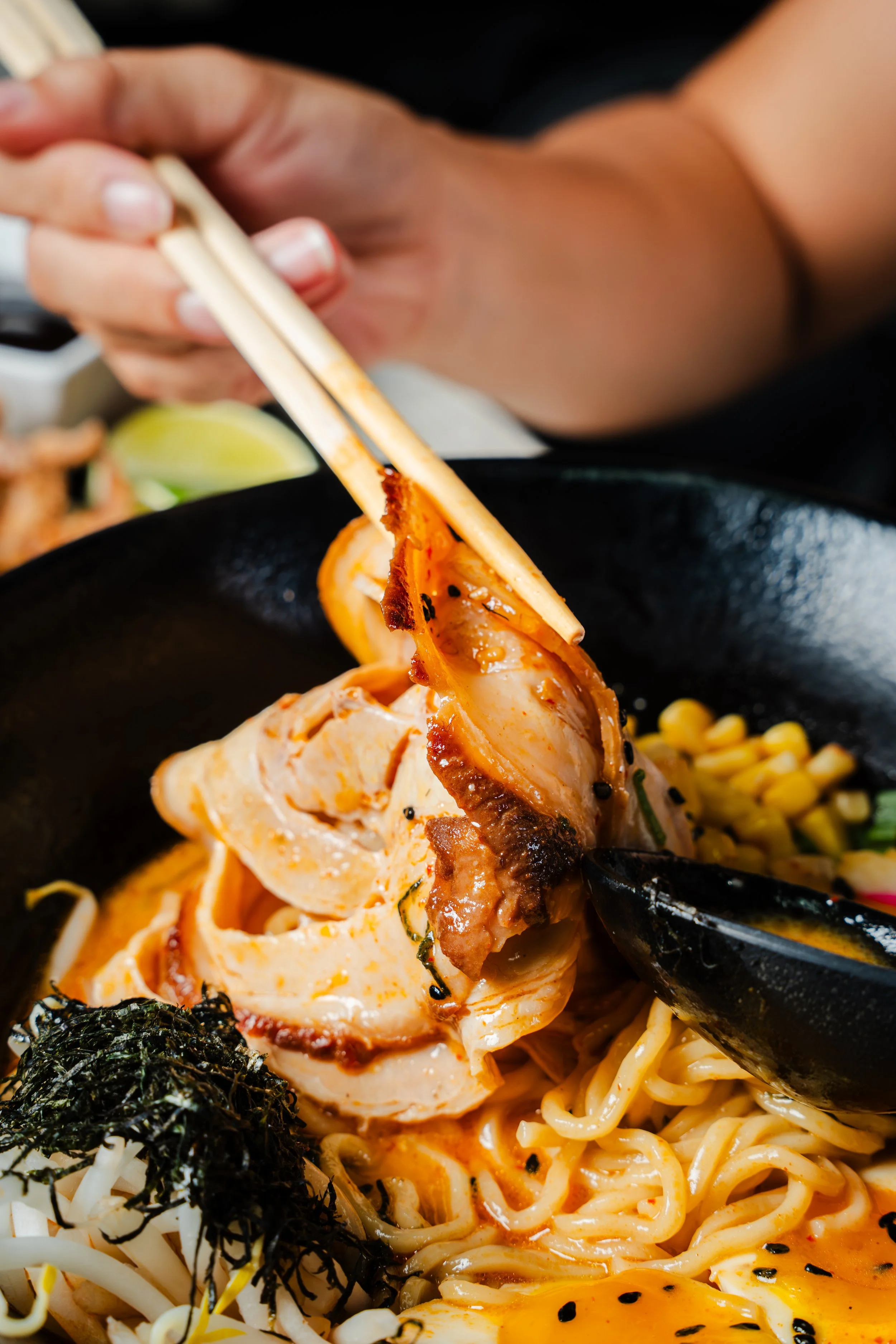 picking up meat with chopsticks