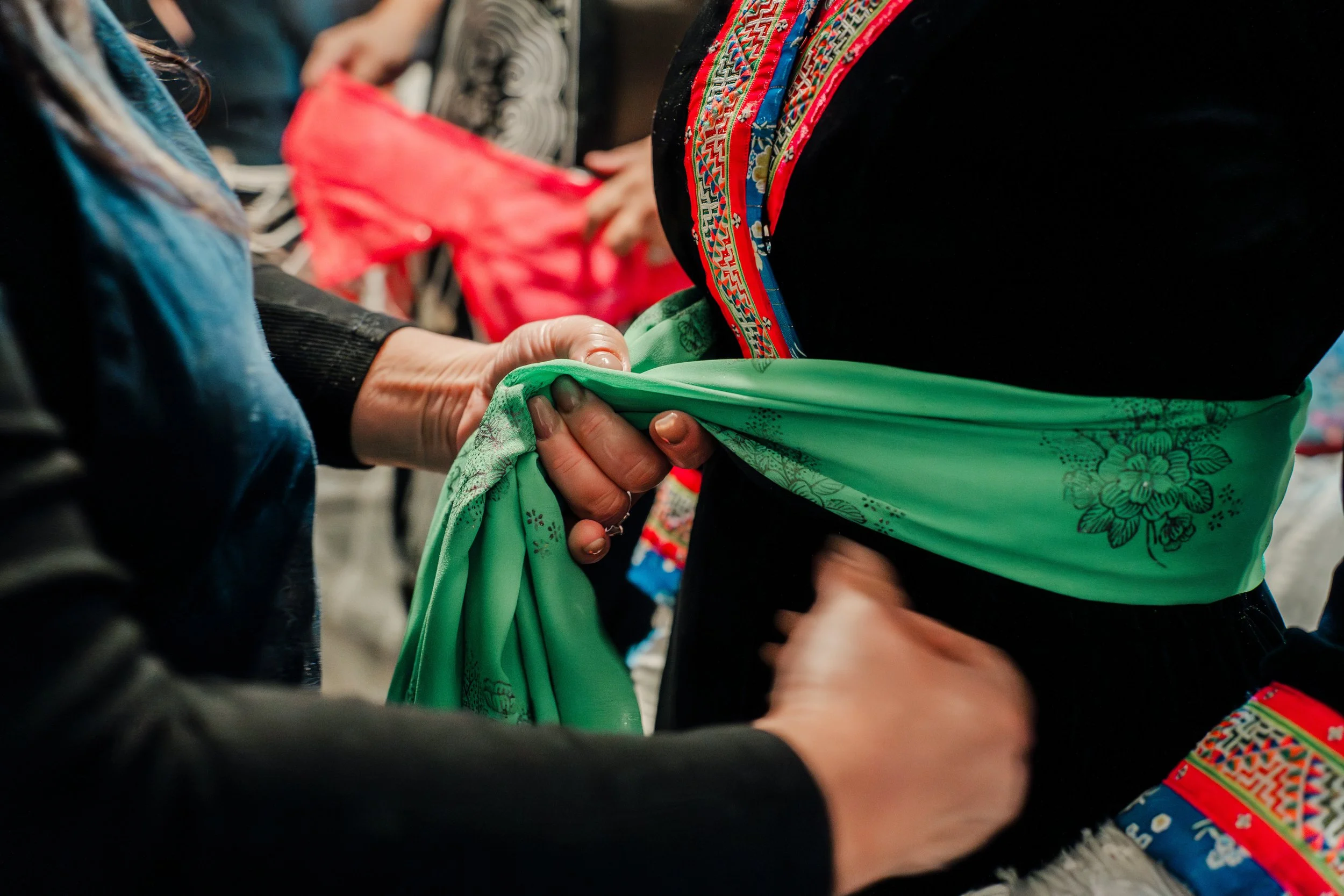 tying cloth around bride at hmong wedding