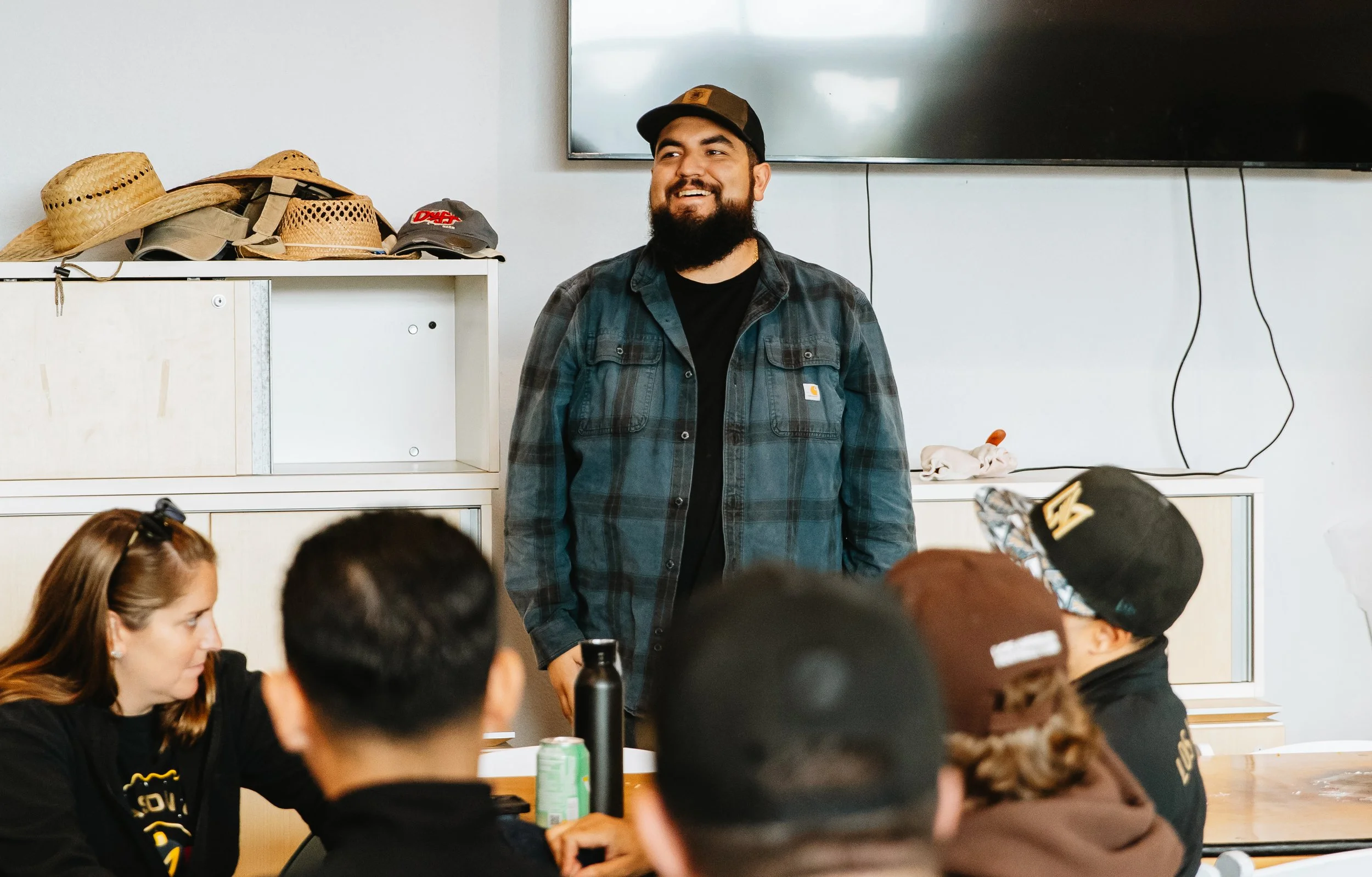 Local farmer Oscar at MudTown Farms in Watts smiling at the high-quality restoration work completed by 128 LAFC volunteers during a b goodly managed corporate service day.