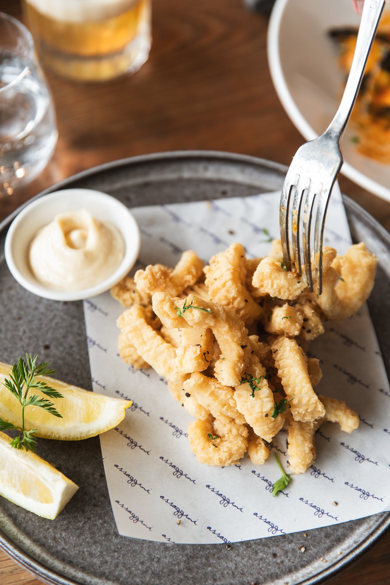Fresh calamari with lemon wedges at Assaggini Mornington.