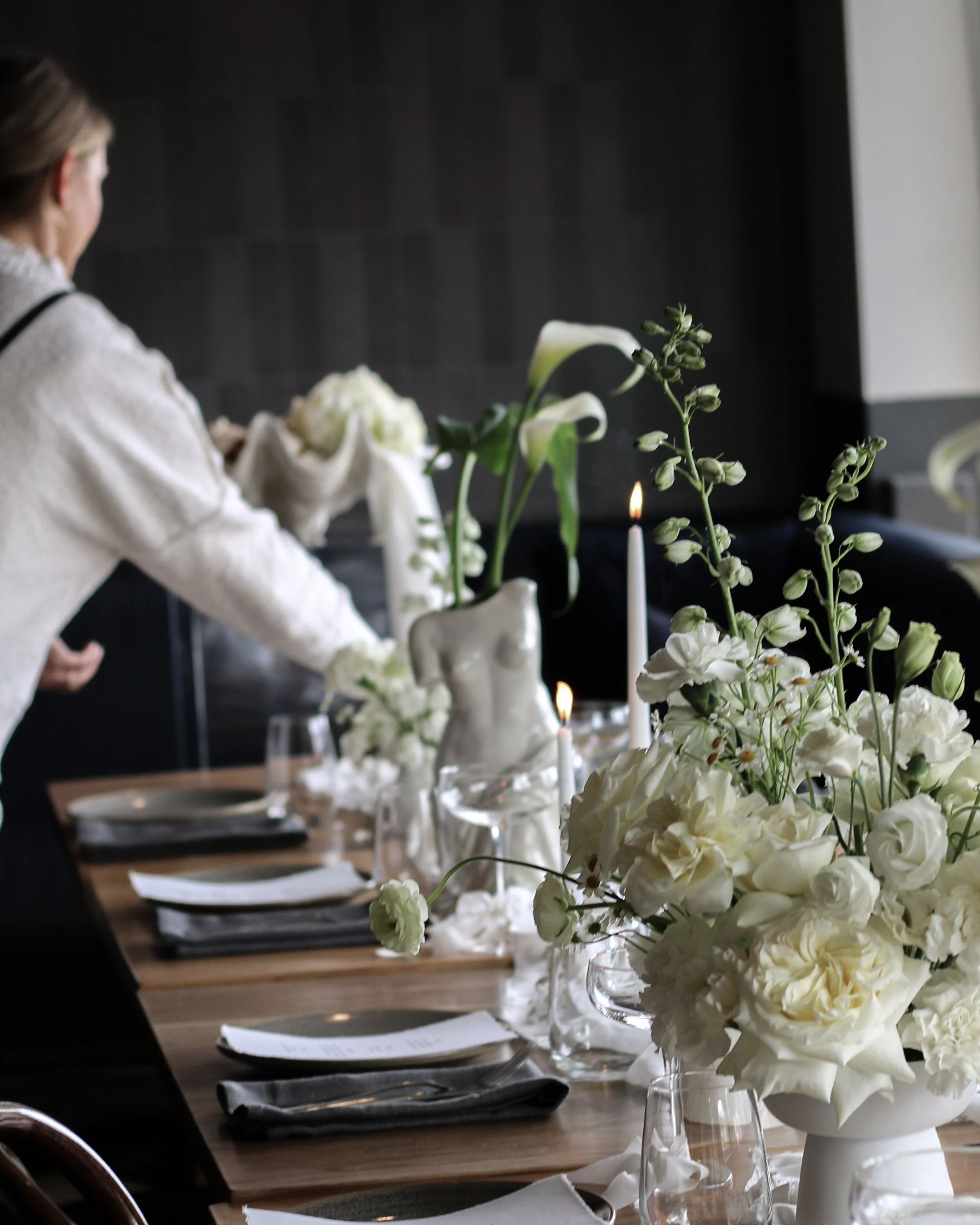 Elegant event table setting with white flowers and candles
