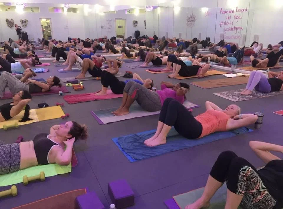 Students practicing Pure Power, a heated class