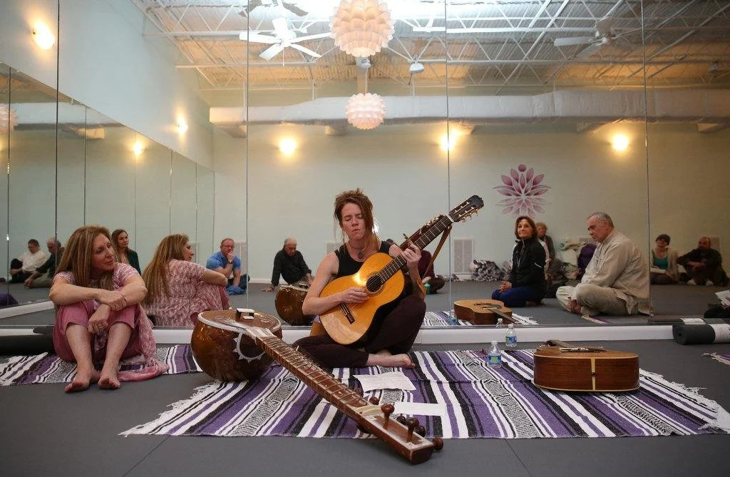 Aimee Wilson plays the sitar and sings at the grand opening of the Above and Beyond studio in Mobile Alabama