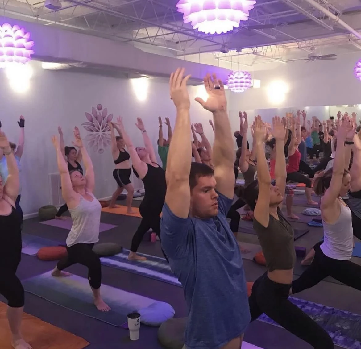 Students practicing a heated yoga class at the studio