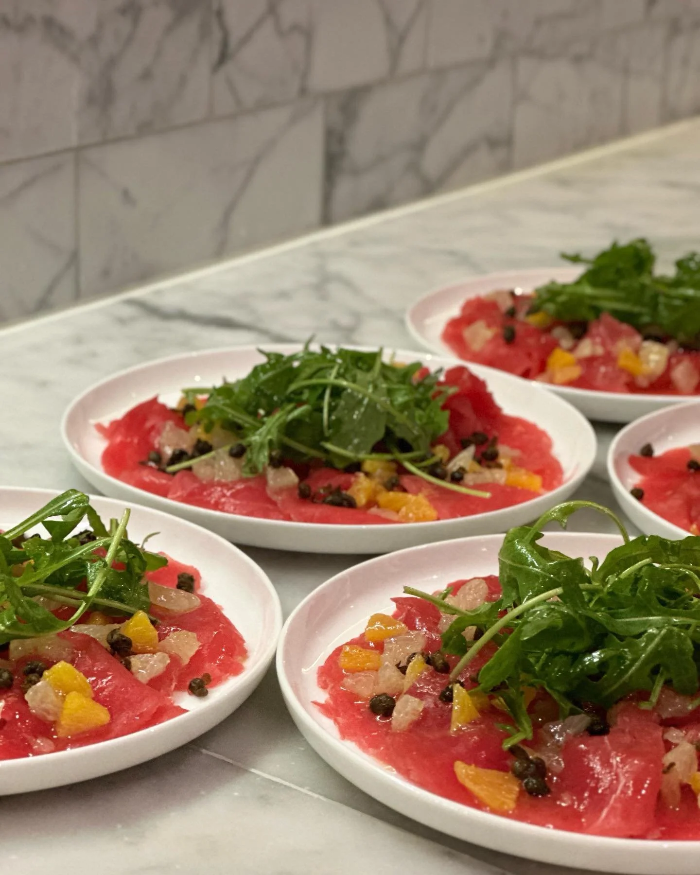 Tuna carpaccio, crispy capers, citrus kernels, and baby rocket.