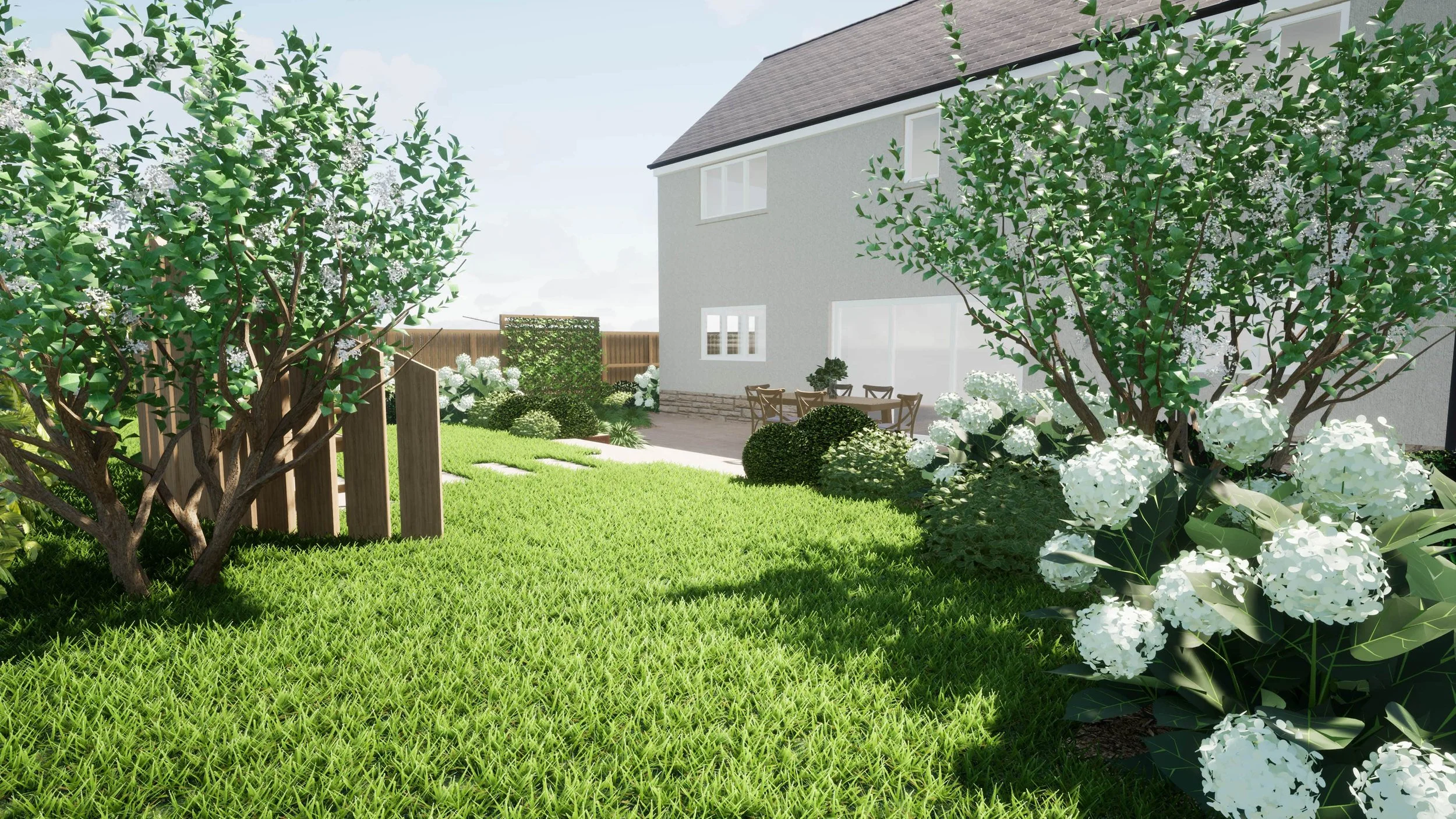 Photo of Penicuik New Build Garden from the back, showing flowers and a seating area