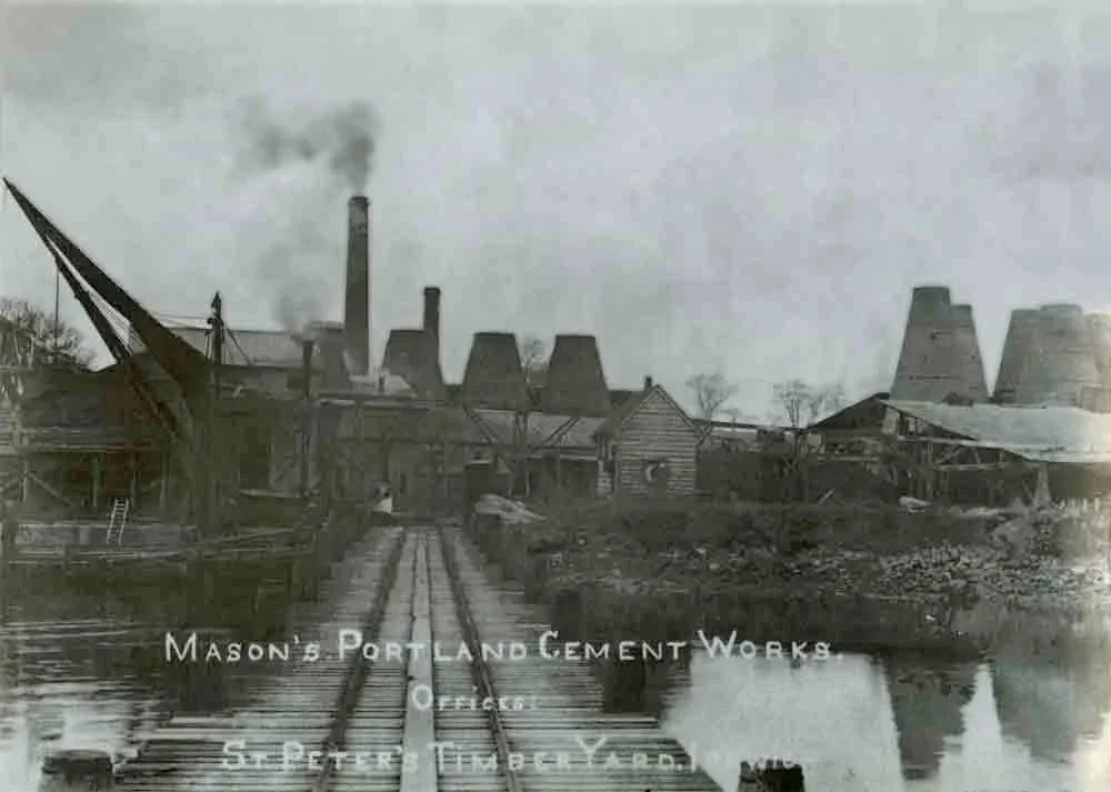 Historic photograph of Waldringfield cement works showing tapered kilns on the riverfront
