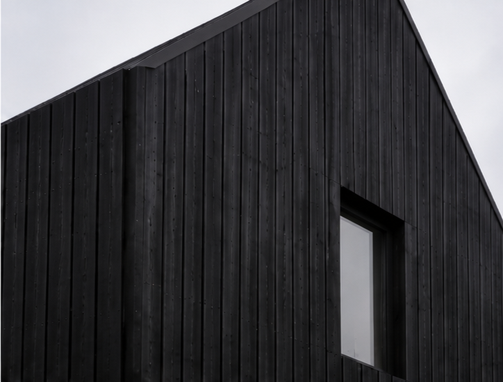 Half House – Close-up detail of black timber cladding and contemporary window surround on new-build house in Cambridge by Fen Studio Architects