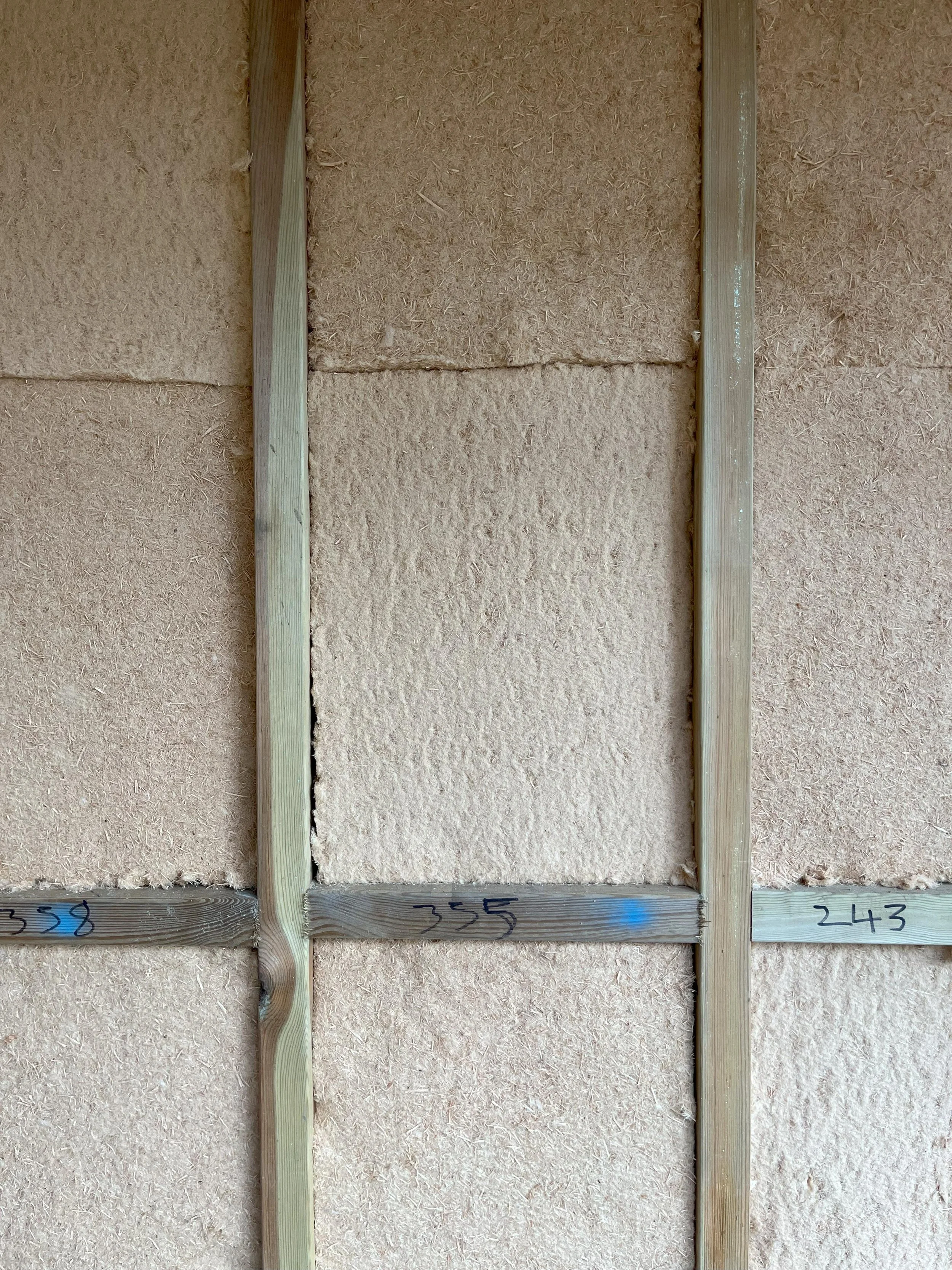 Pavaflex wood fibre insulation fitted between timber wall studs at Hereward House Passive House project