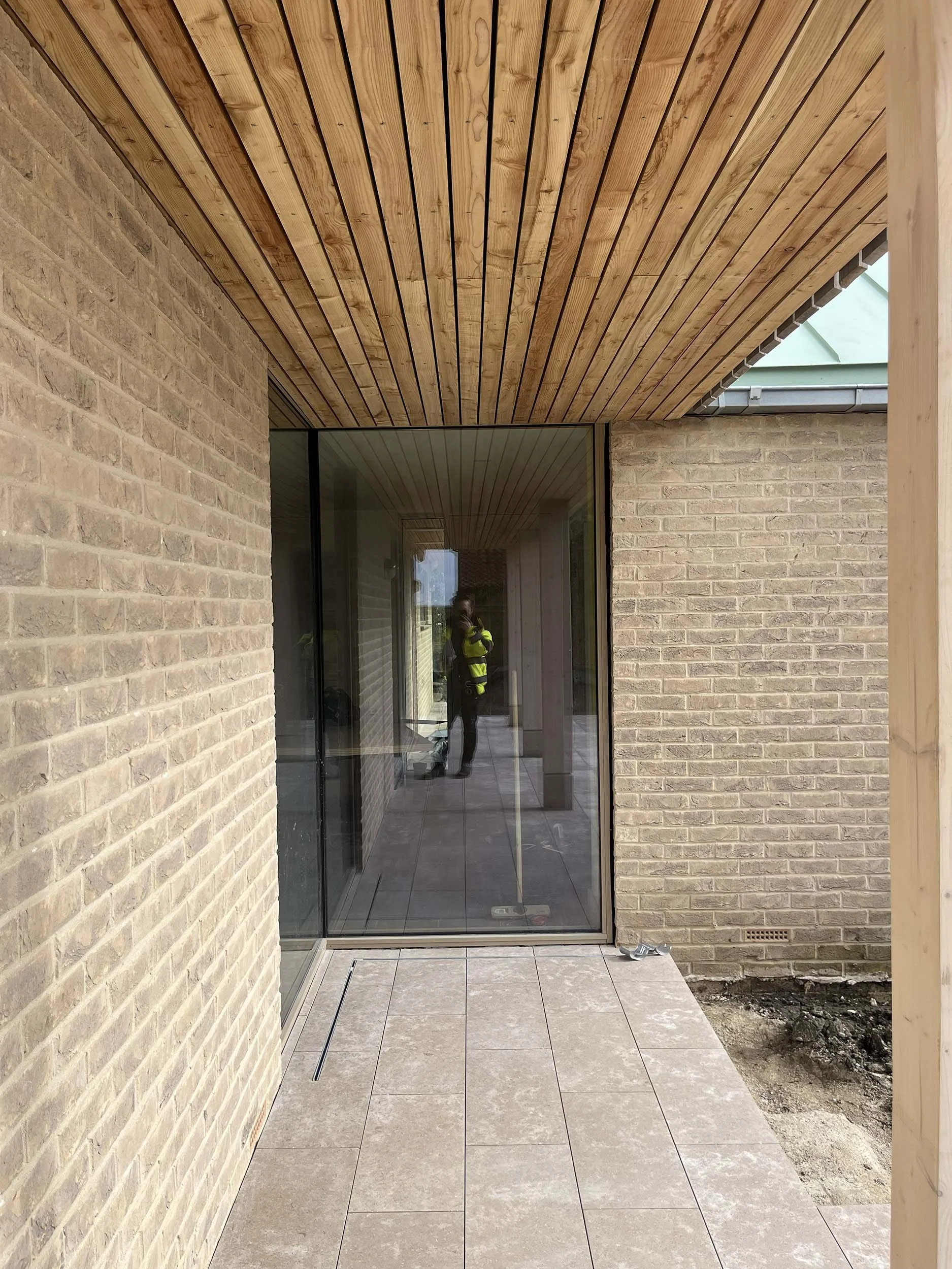 Hereward House – Covered external walkway with timber soffit and glazed courtyard connection in Aldreth, Ely, Cambridgeshire