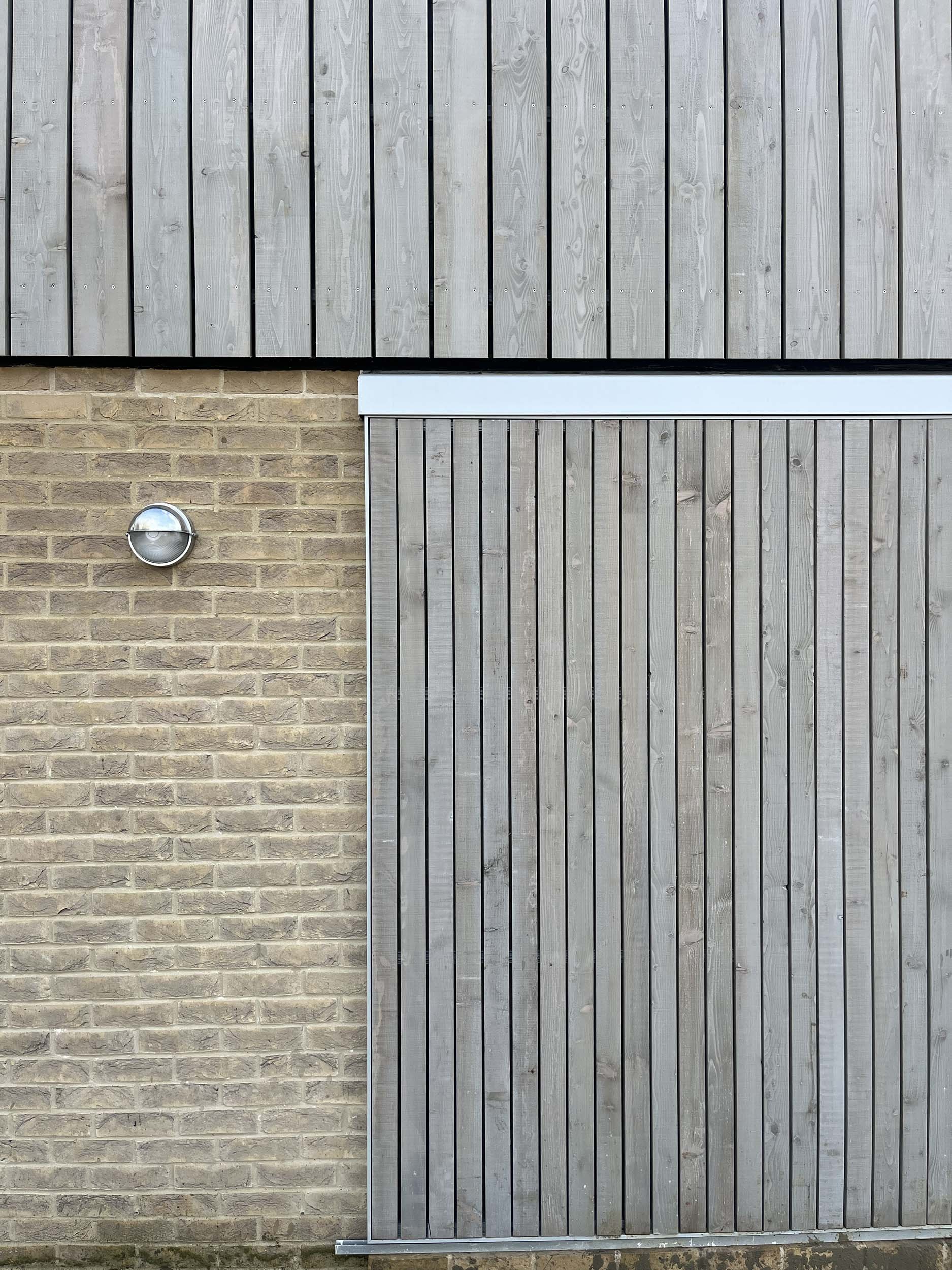Hereward House – Material palette detail showing brickwork and vertical timber cladding in Aldreth, Ely, Cambridgeshire