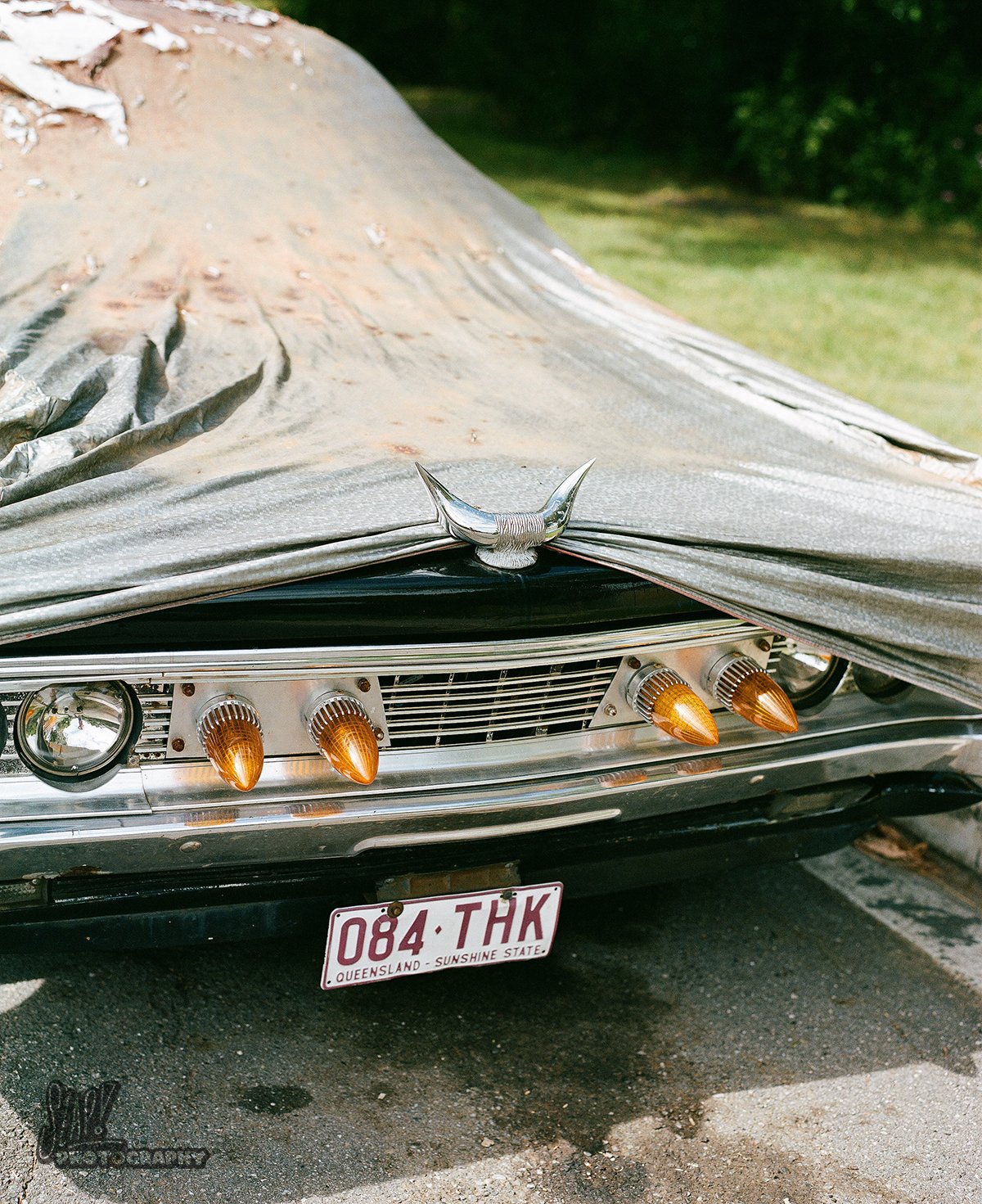 Black Dodge Phoenix Grille with Bullhorns and Modifications under Tarp