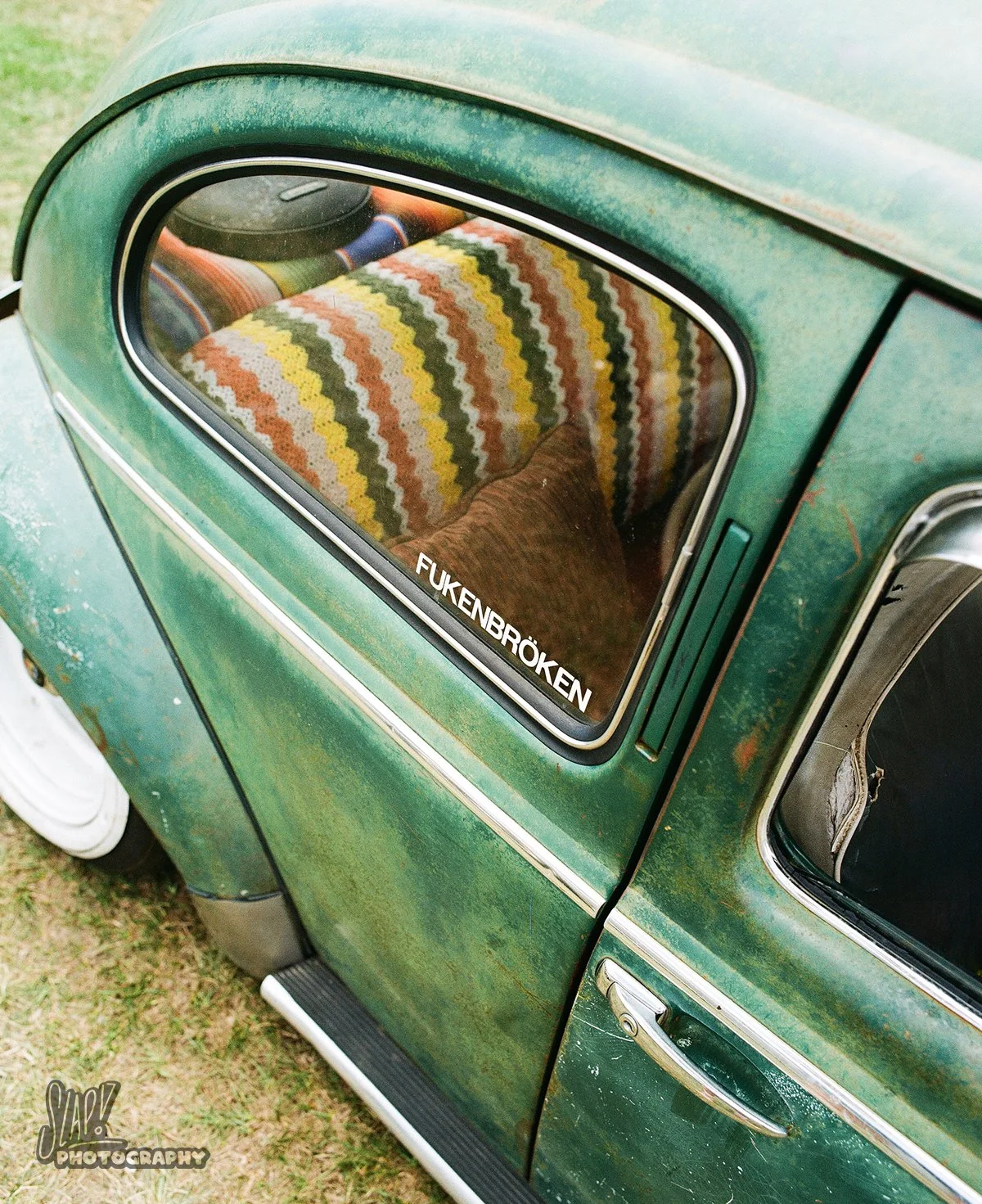 Green Volkswagen Beetle Rat Side with Rug in Backseat and Sticker