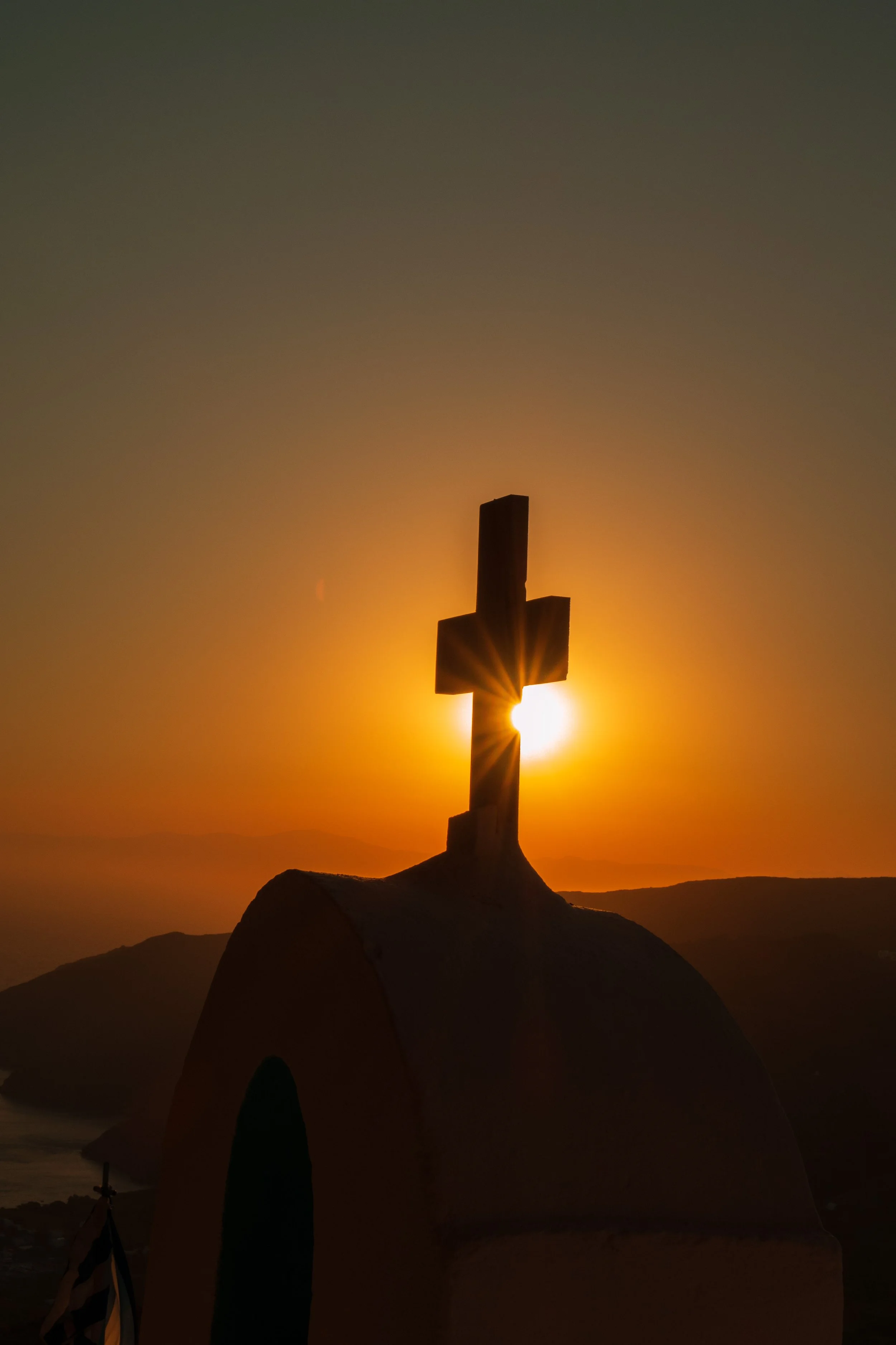 The Vassalos family chapel perched on the cliffside above Langada, Amorgos, at sunset.