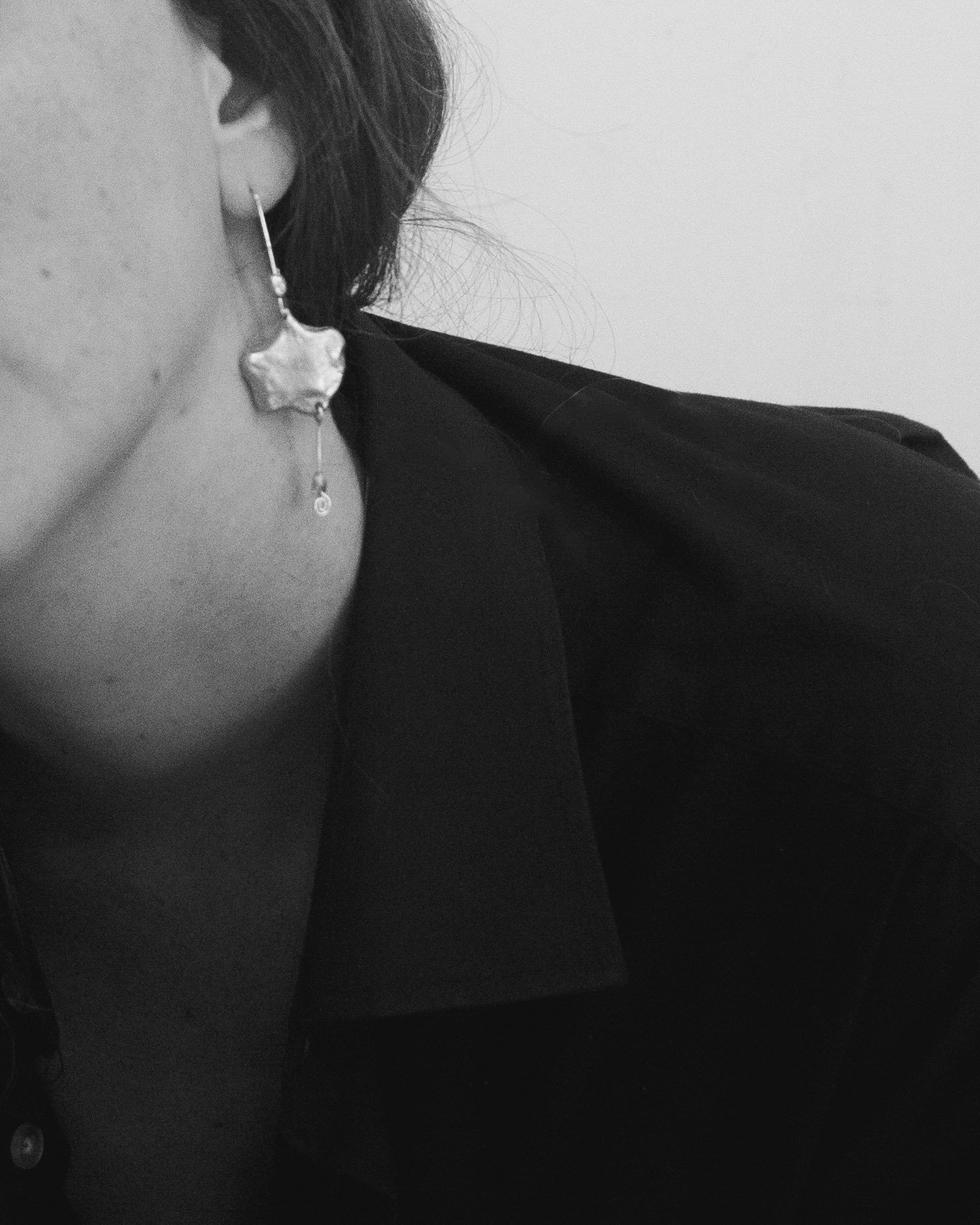 Upclose shot of the Starburst Earrings on model