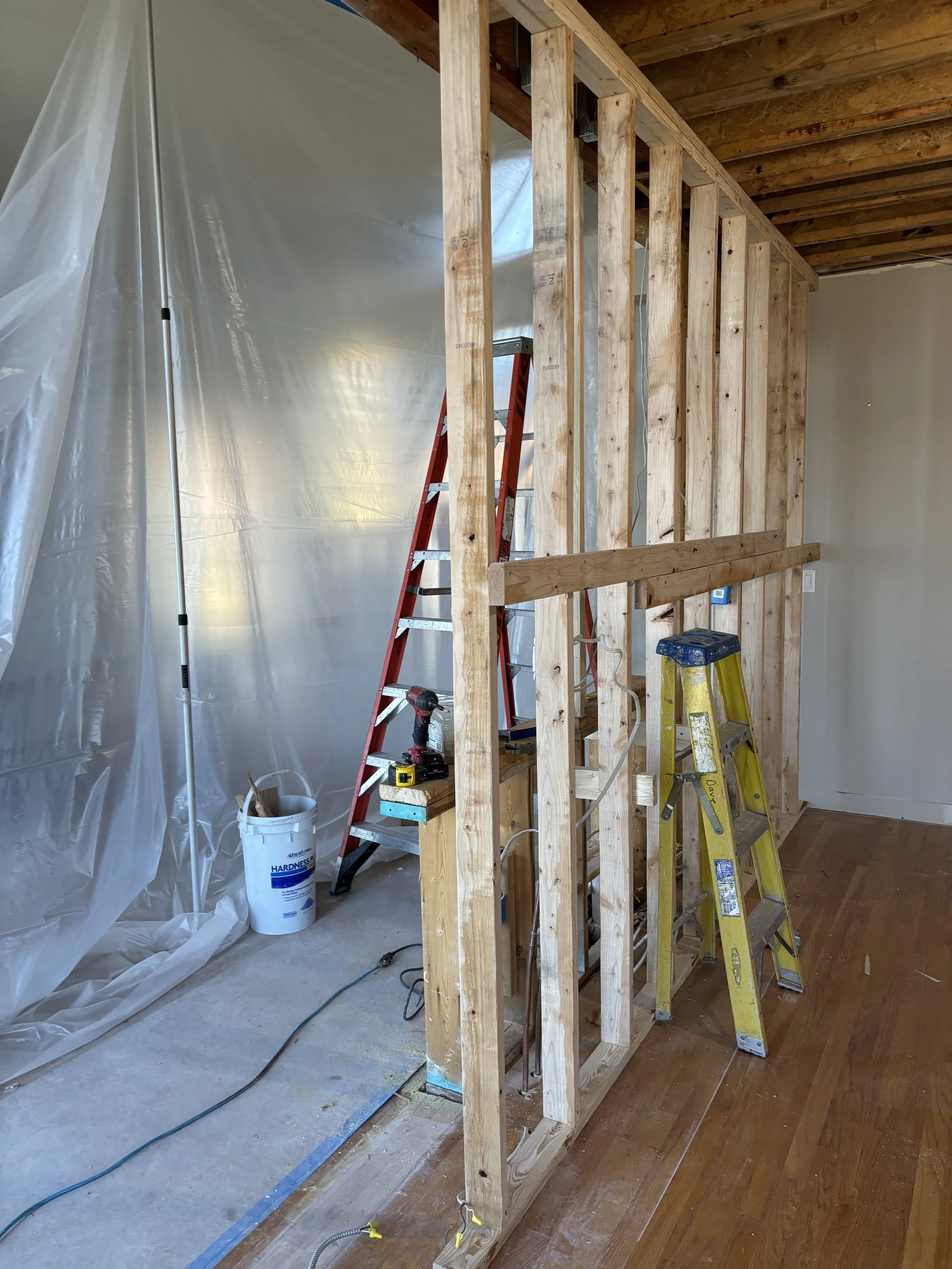 Kitchen renovation in progress with new wall framing during construction by FD Design Co.