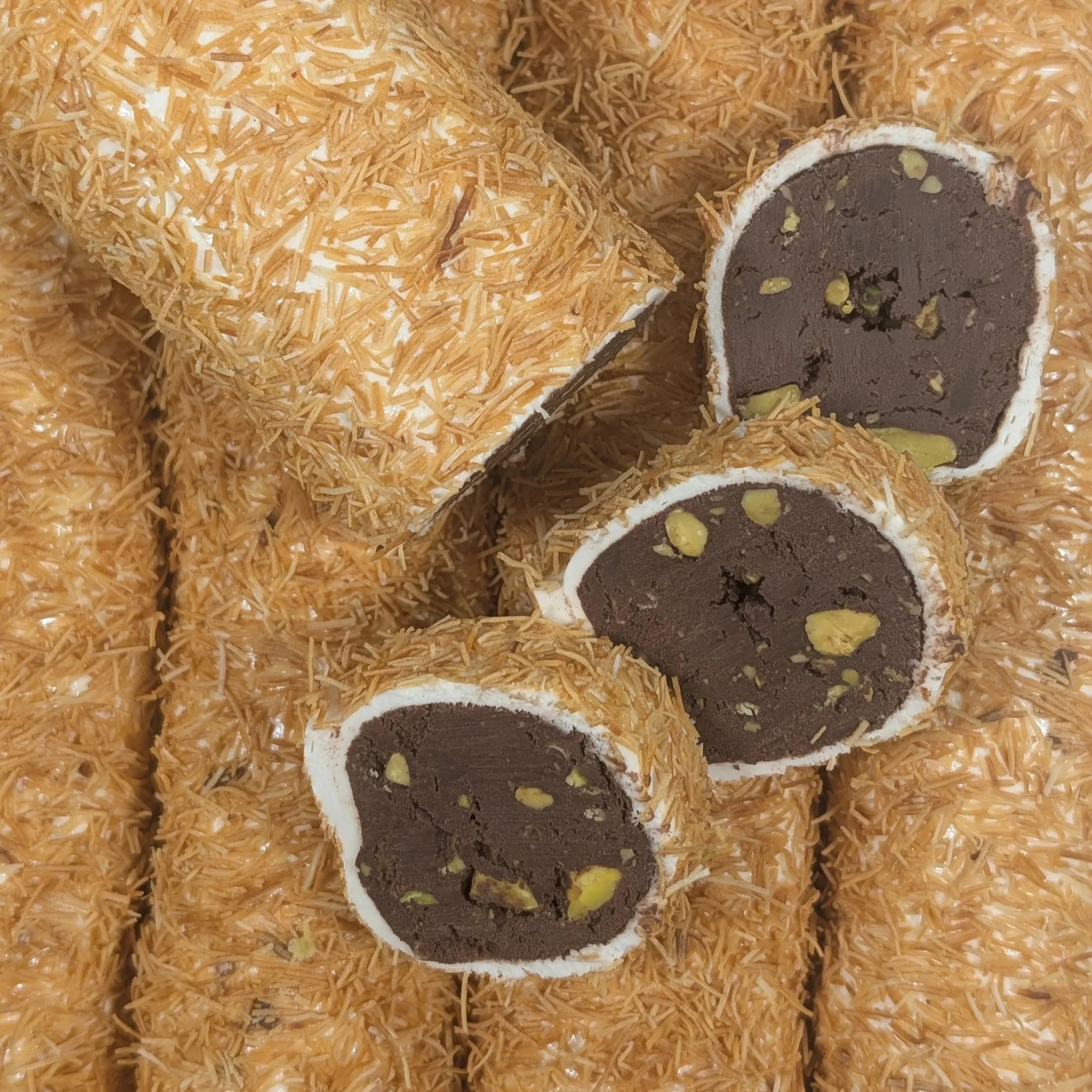 Detailing the contrast between the crunchy Kunafa and smooth chocolate Turkish Delight interior.