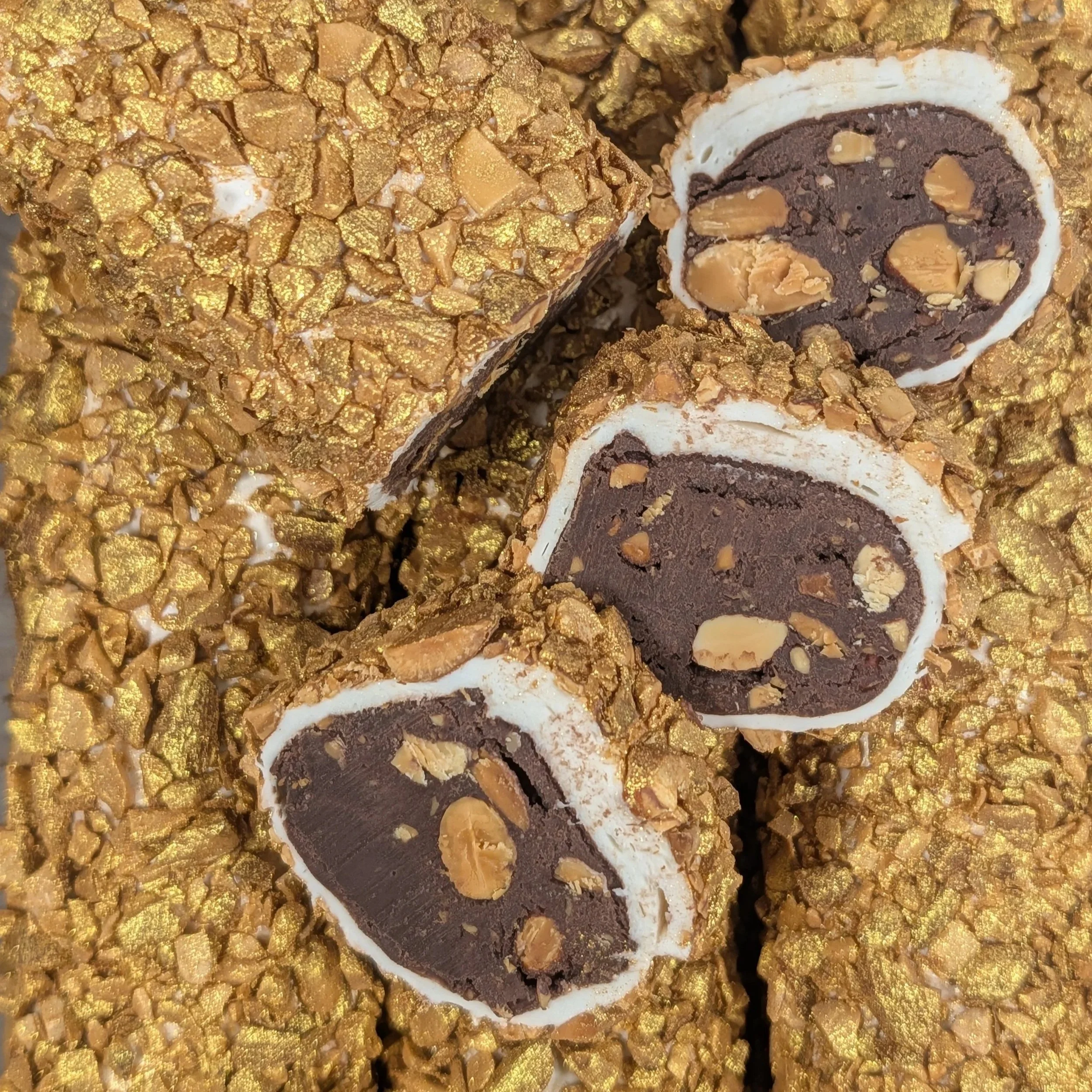 Detailing the premium chocolate filling and the shimmer of golden almond Turkish Delight.