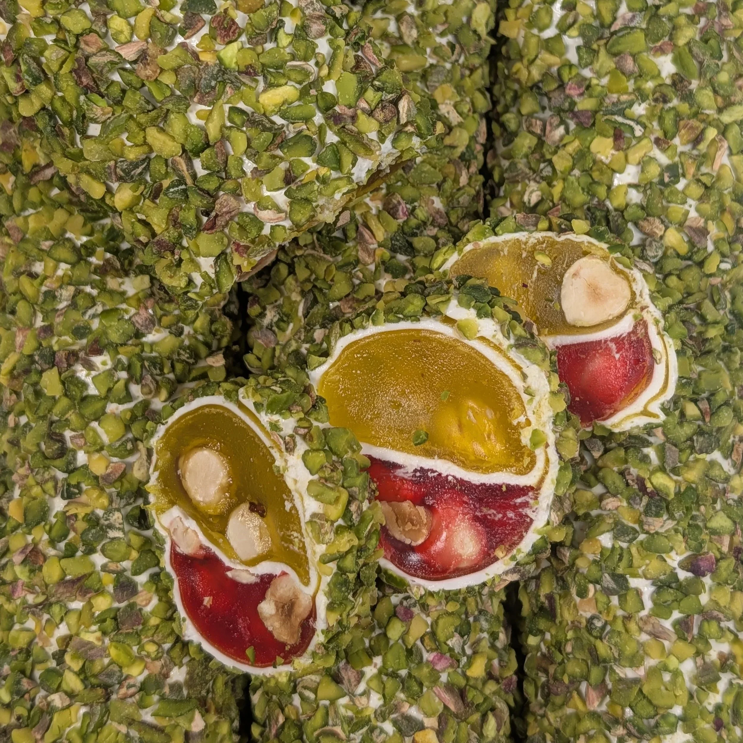 Artisanal craftsmanship showcasing the colorful citrus and berry layers of our luxury Turkish Delight.