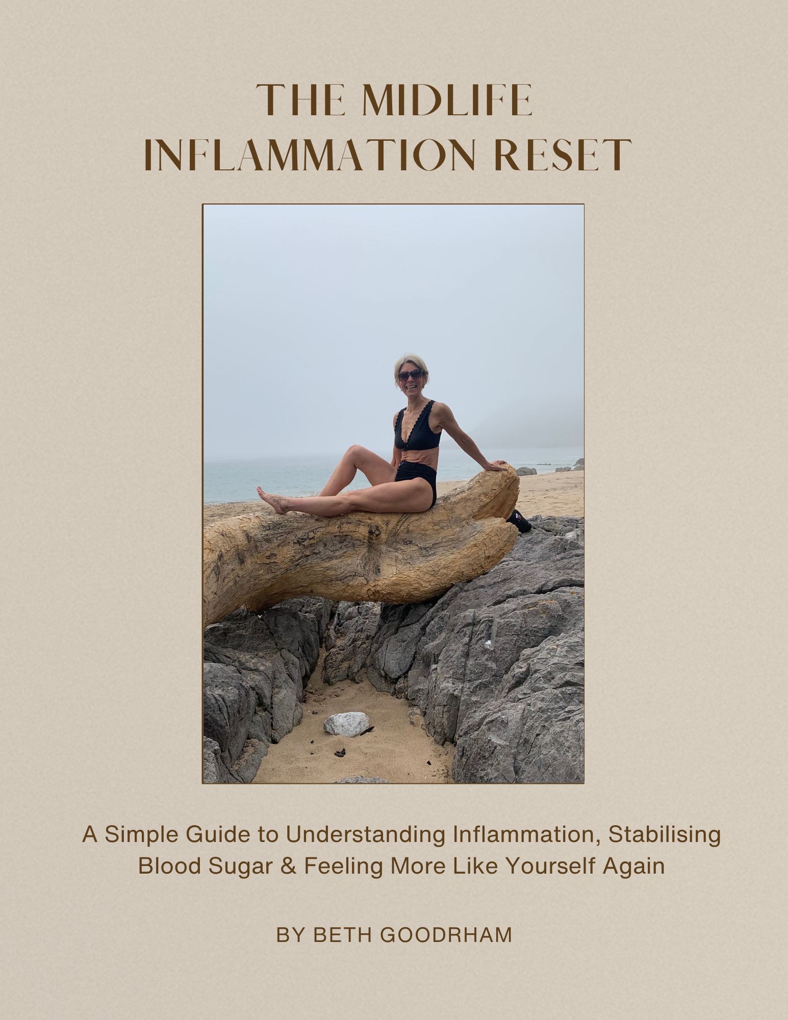 Woman sitting on log on a beach looking happy