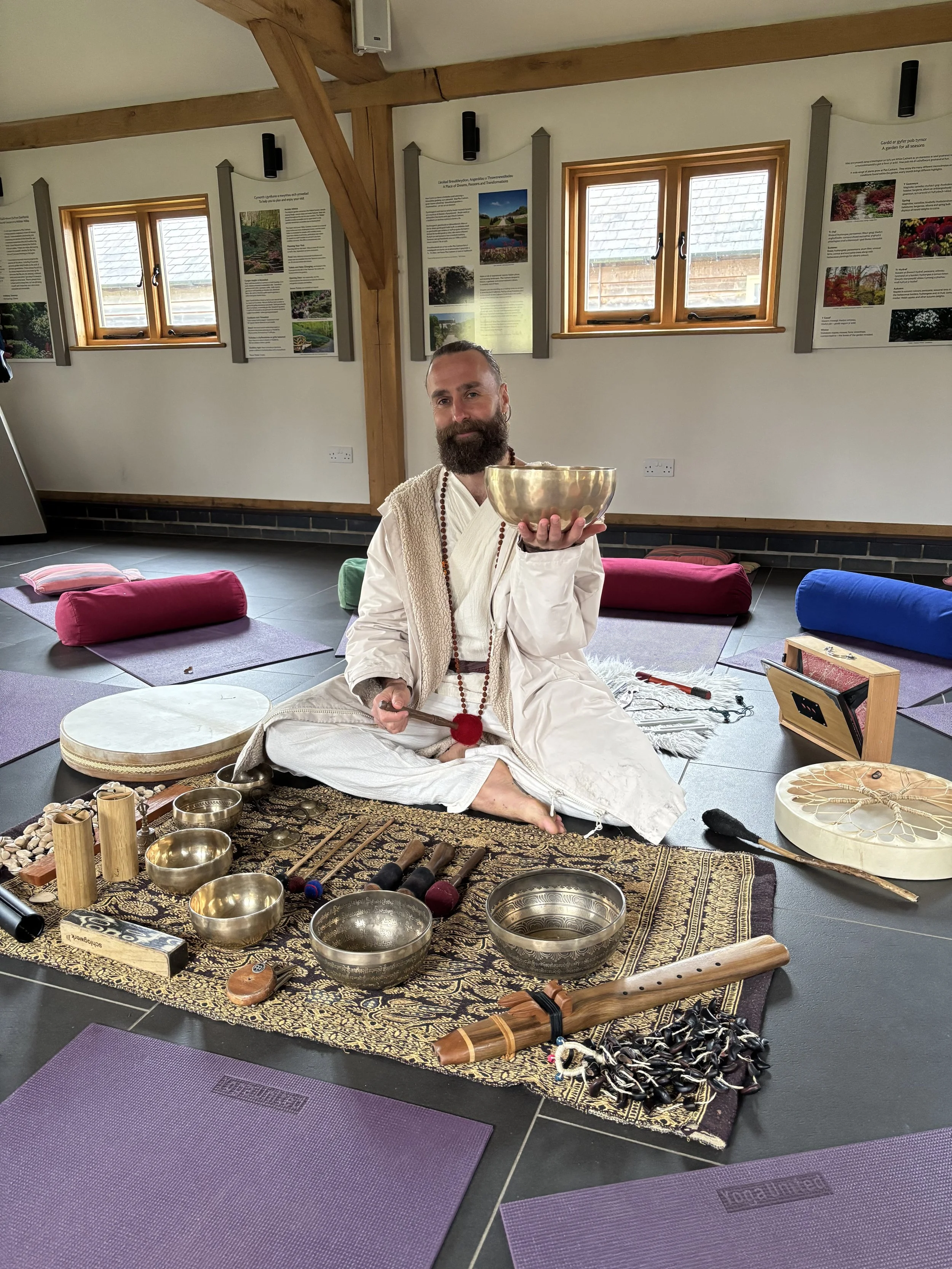 A tranquil sound journey session at a wellness retreat in North Wales, featuring Tibetan singing bowls and other meditative instruments.