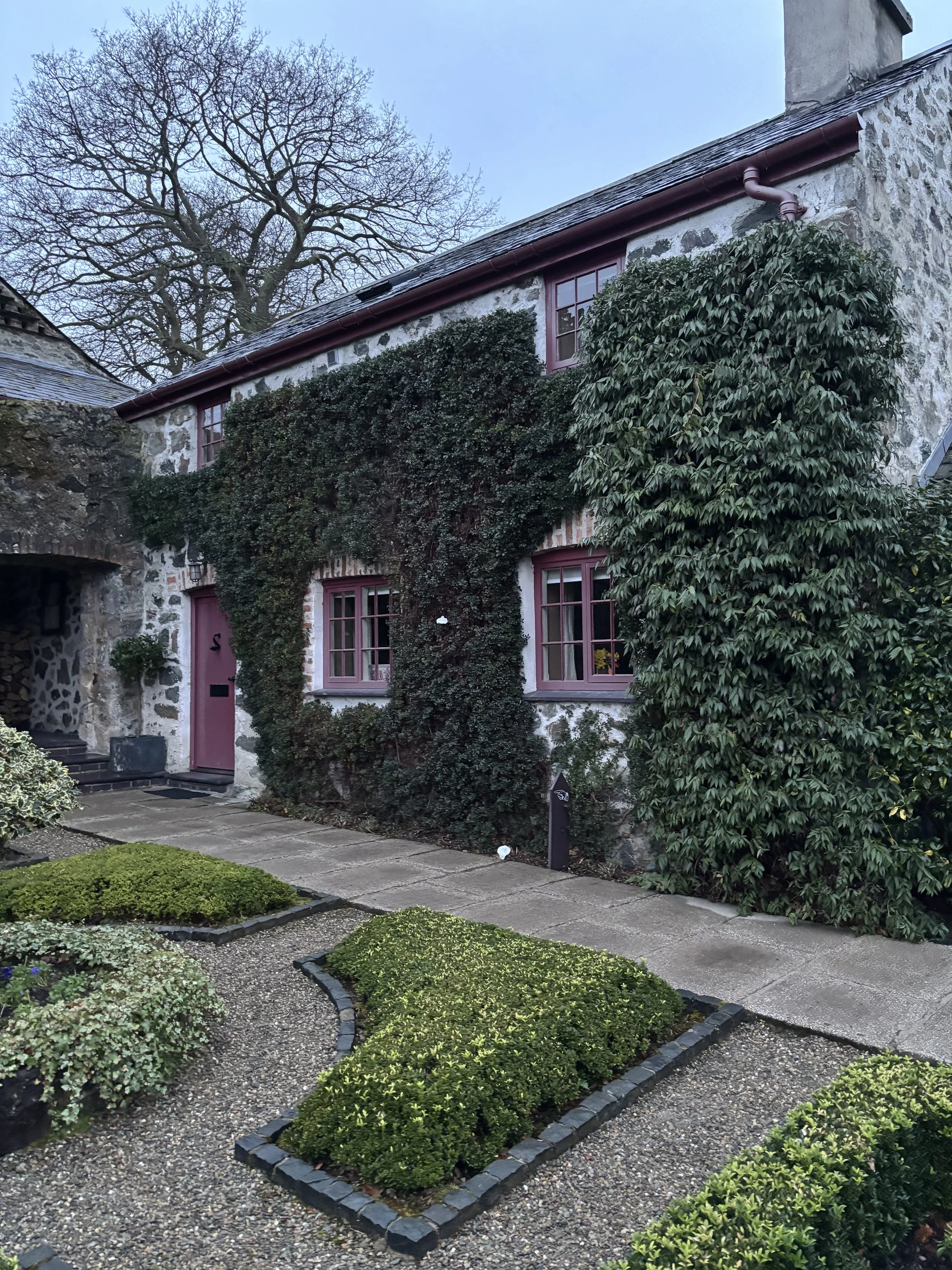 A scenic view of Plas Cadnant, the stunning retreat venue in North Wales, featuring lush gardens and historic architecture
