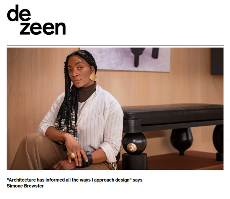 Artist Simone Brewster featured in Dezeen magazine with a photo of her sitting in front of her artwork (a bench made of ebonised wood that forms a part of a sculptural furniture series). 