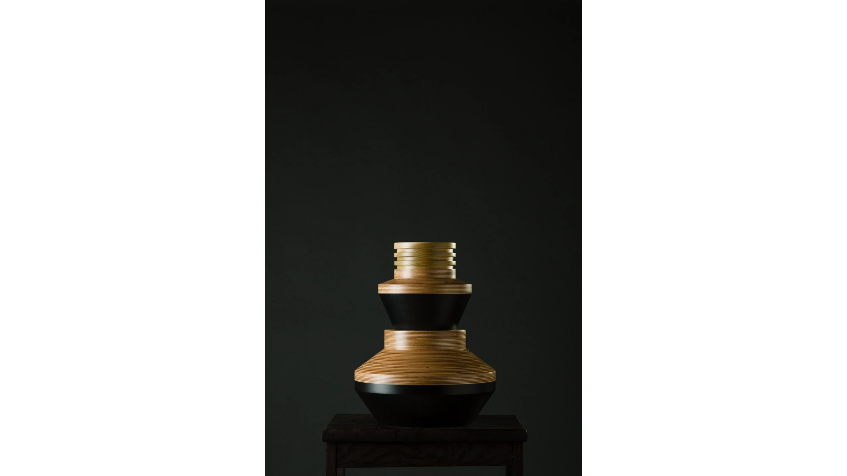 A sculptural vessel that forms a part of the Tropical Noire collection by artist, Simone Brewster. The sculpture is made of carved timber wood, drawing on African cereminal forms. Hand-crafted wood sculpture.