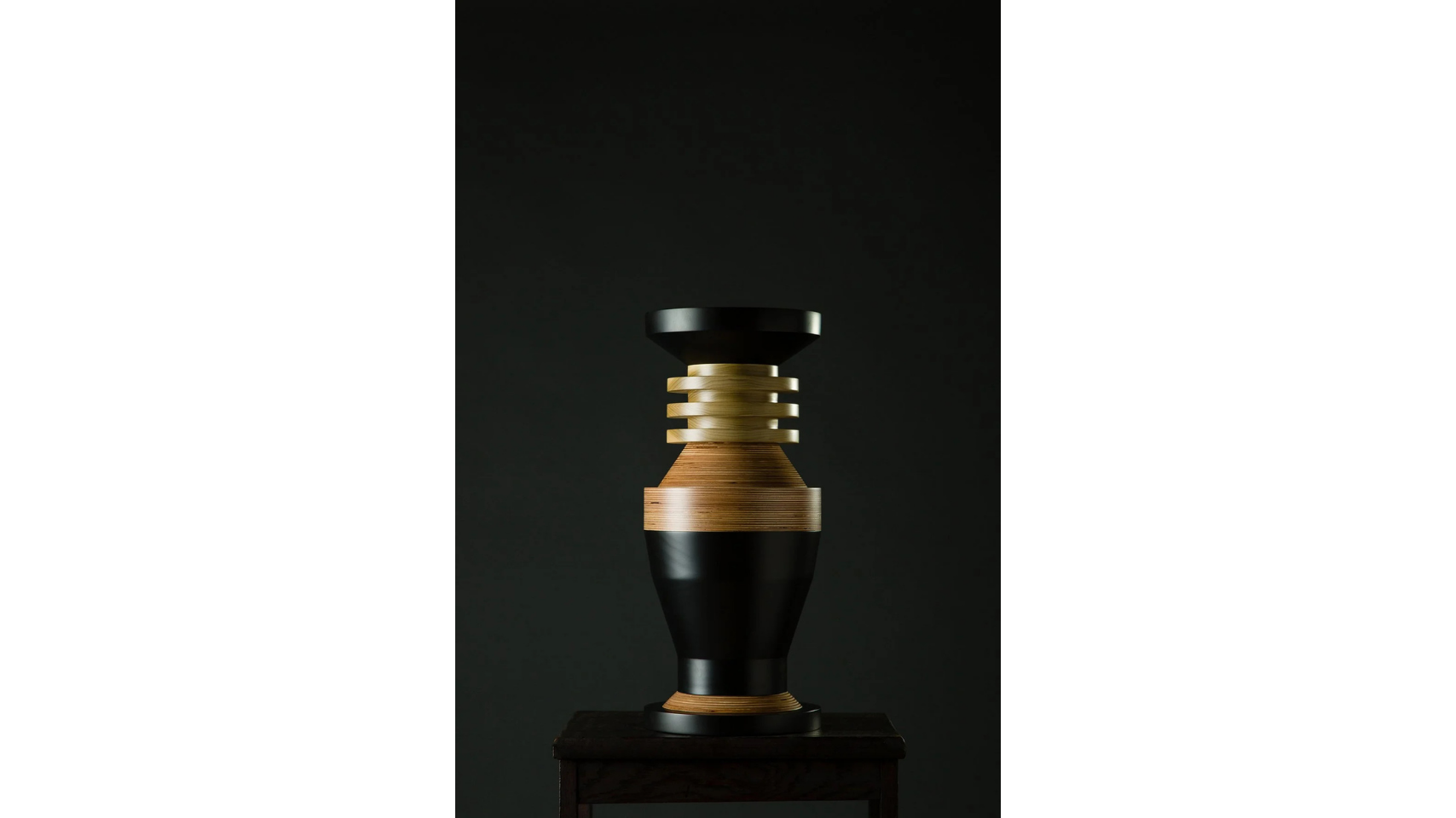 A sculptural vessel that forms a part of the Tropical Noire collection by artist, Simone Brewster. The sculpture is made of carved timber wood, drawing on African cereminal forms. Hand-crafted wood sculpture.