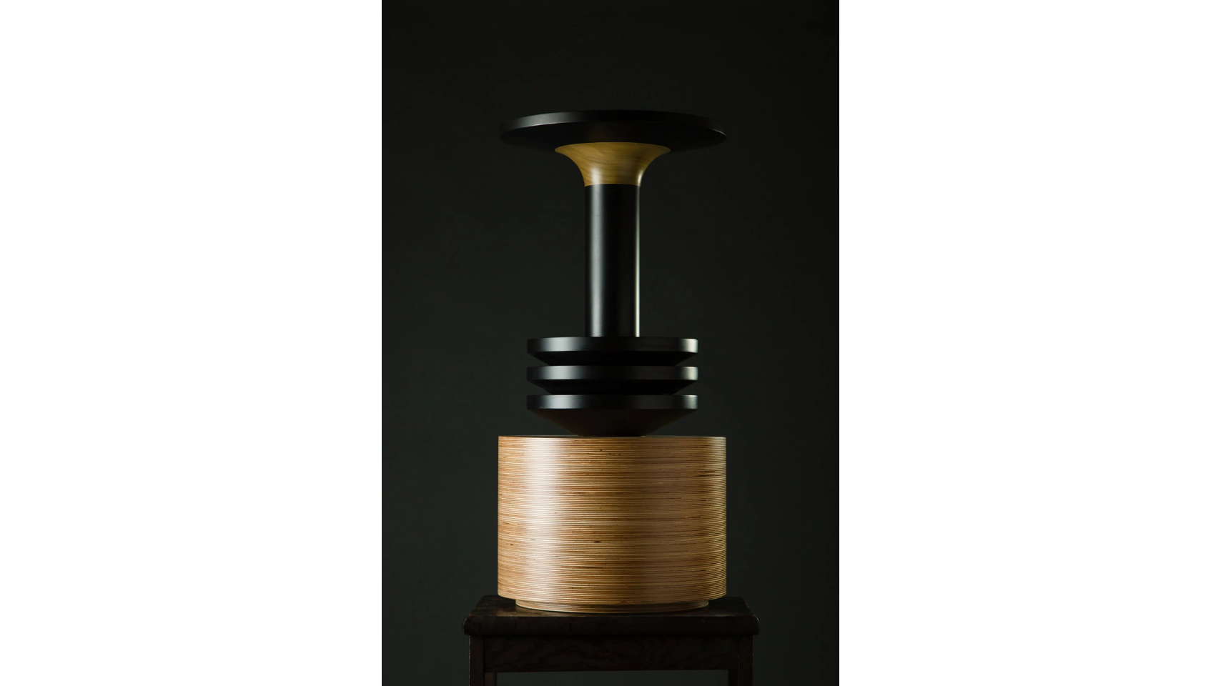 A sculptural vessel that forms a part of the Tropical Noire collection by artist, Simone Brewster. The sculpture is made of carved timber wood, drawing on African cereminal forms. Hand-crafted wood sculpture.