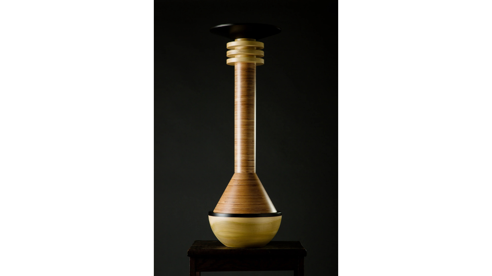 A sculptural vessel that forms a part of the Tropical Noire collection by artist, Simone Brewster. The sculpture is made of carved timber wood, drawing on African cereminal forms. Hand-crafted wood sculpture.