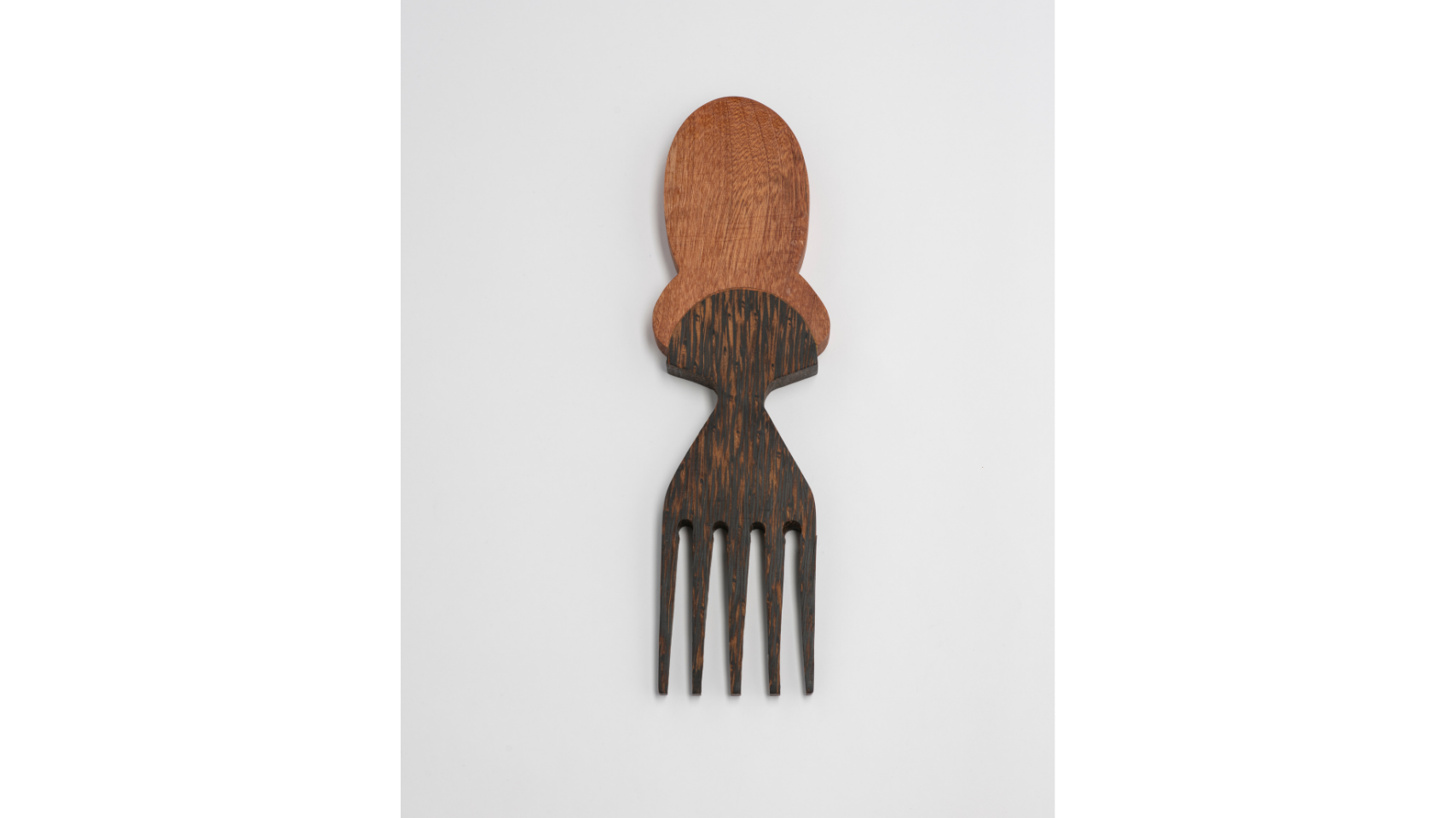 Five Heritage Comb hand-carved from black palm wood with accents of sapele. The comb draws on the distinctive hairstyles of specific African communities