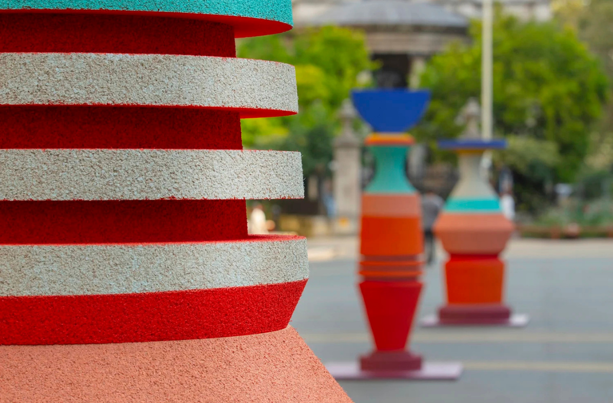 A close up detail shot of the cork sculpture. The sculpture in made of red, light grey and pale orange, with the textures of the cork visible in the image.
