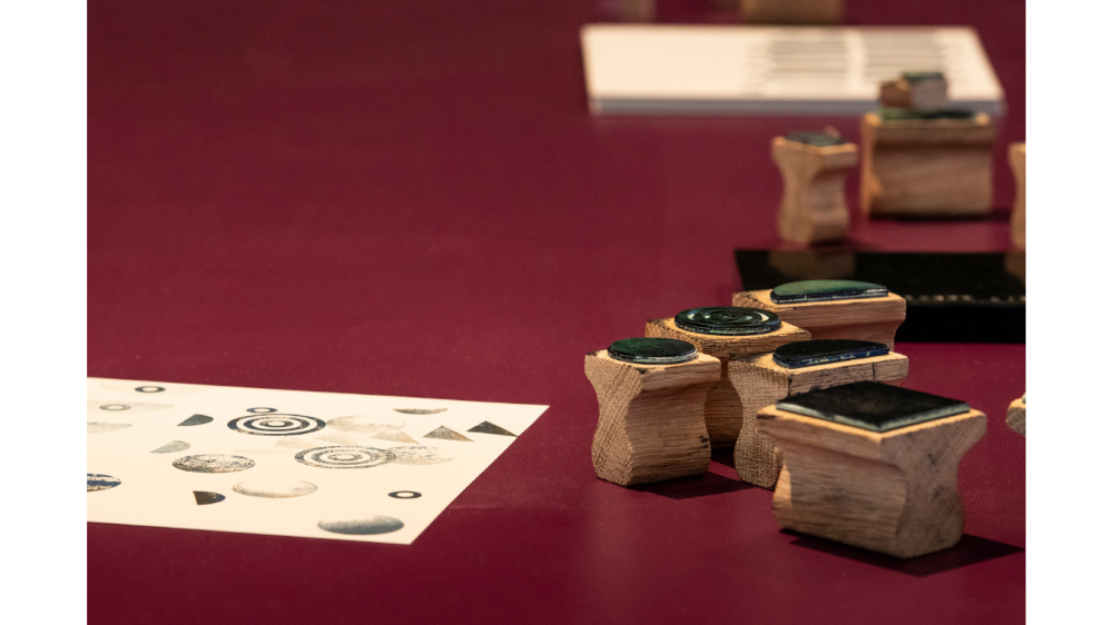 A closeup of stamps made by Simone Brewster along with stamped paper