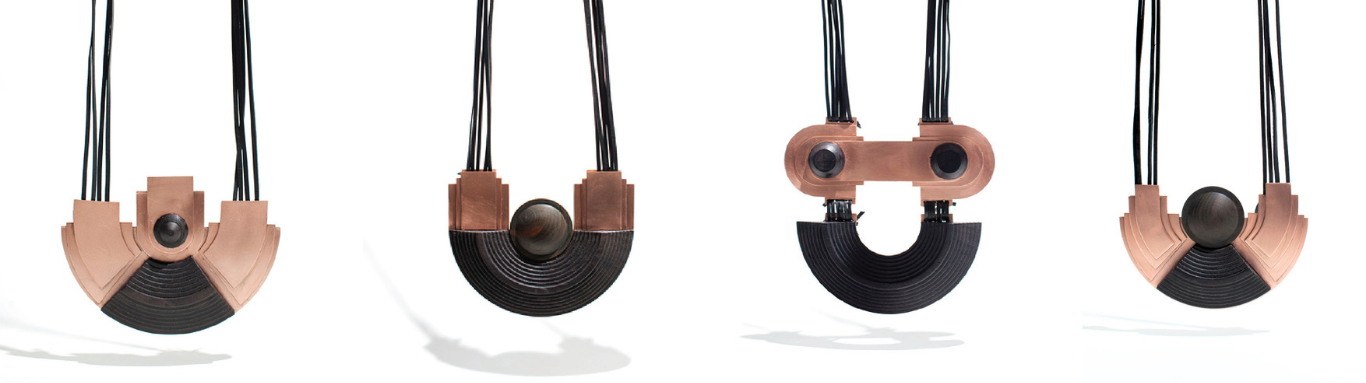 Four handmade necklaces by Simone Brewster lined up together each made of ebony wood and lignum vitae