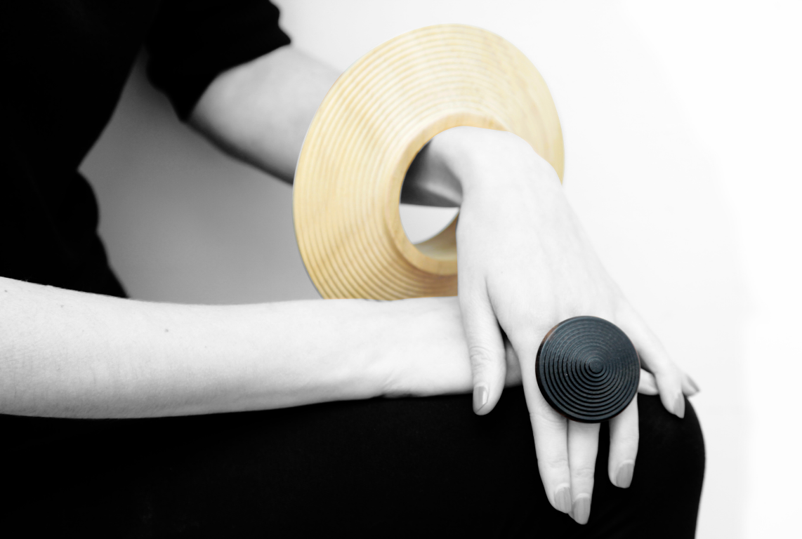 A bracelet and a ring by Simone Brewster crrafted out of wood, modelled on a woman's arm and hand