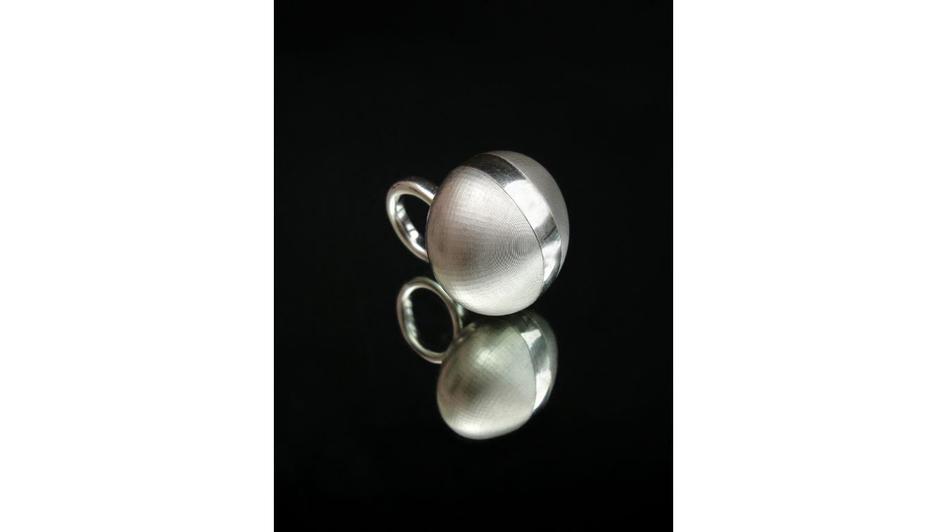 Close up of silver ring in orb shape by Simone Brewster