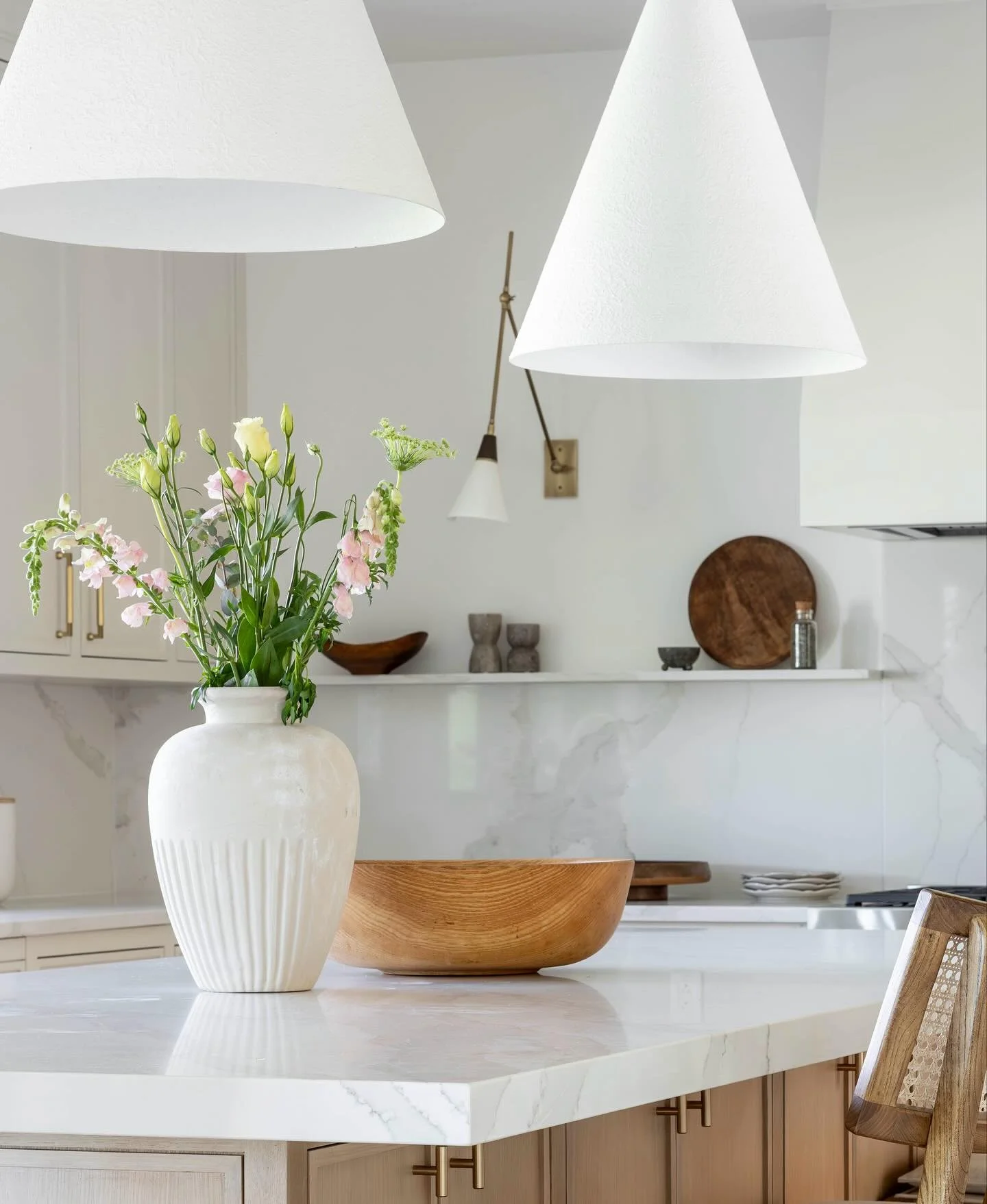 This corner captures everything we love about this kitchen. Simple details like the accent light and marble shelf bring so much warmth and character. It&rsquo;s the quiet layers- the textures, the light, the small moments- that truly make a space com