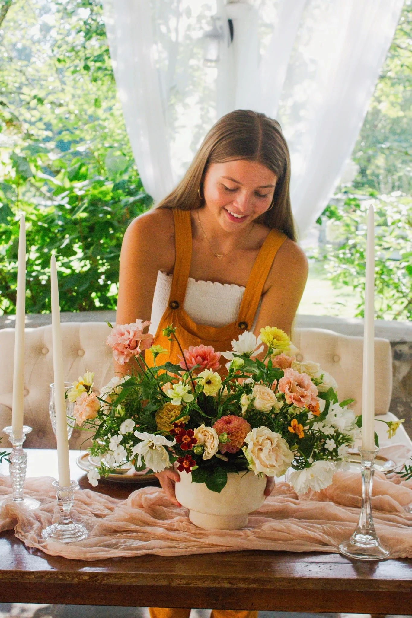 Woman in overalls, woman with flower arrangement