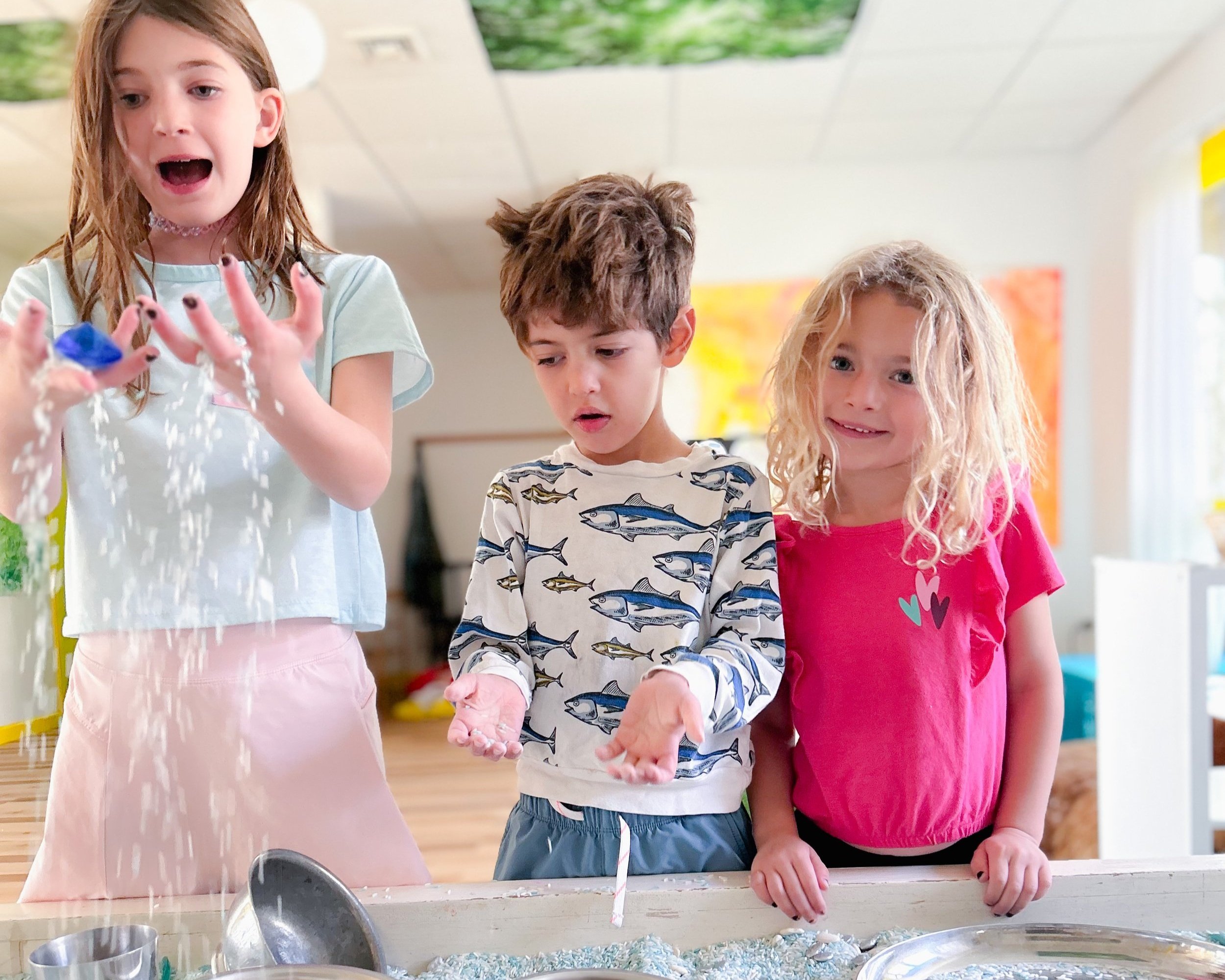 children play with water and ice in sensory art studio